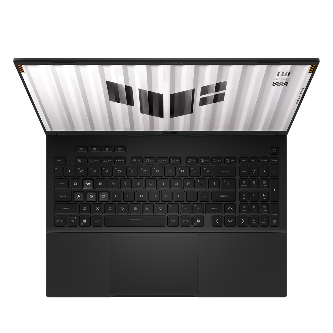 Czarny laptop jest otwarty. Ekran wyświetla wzór. Klawiatura jest widoczna, z klawiszami i panelem dotykowym. Marka to ASUS.