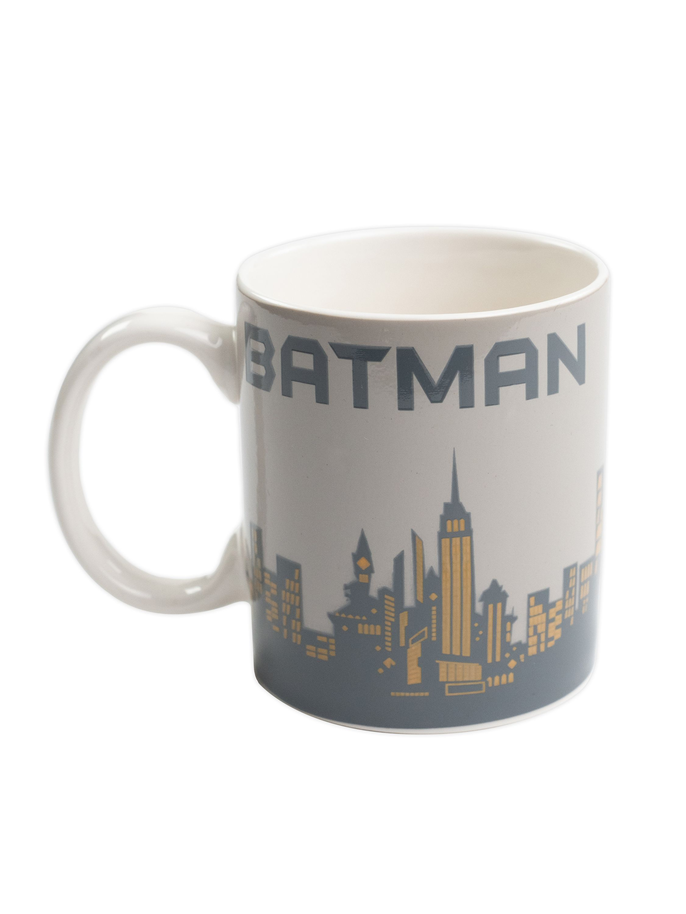 Eine Batman-Tasse mit Skyline-Design. Die Tasse ist weiß mit dem Wort BATMAN in Grau.