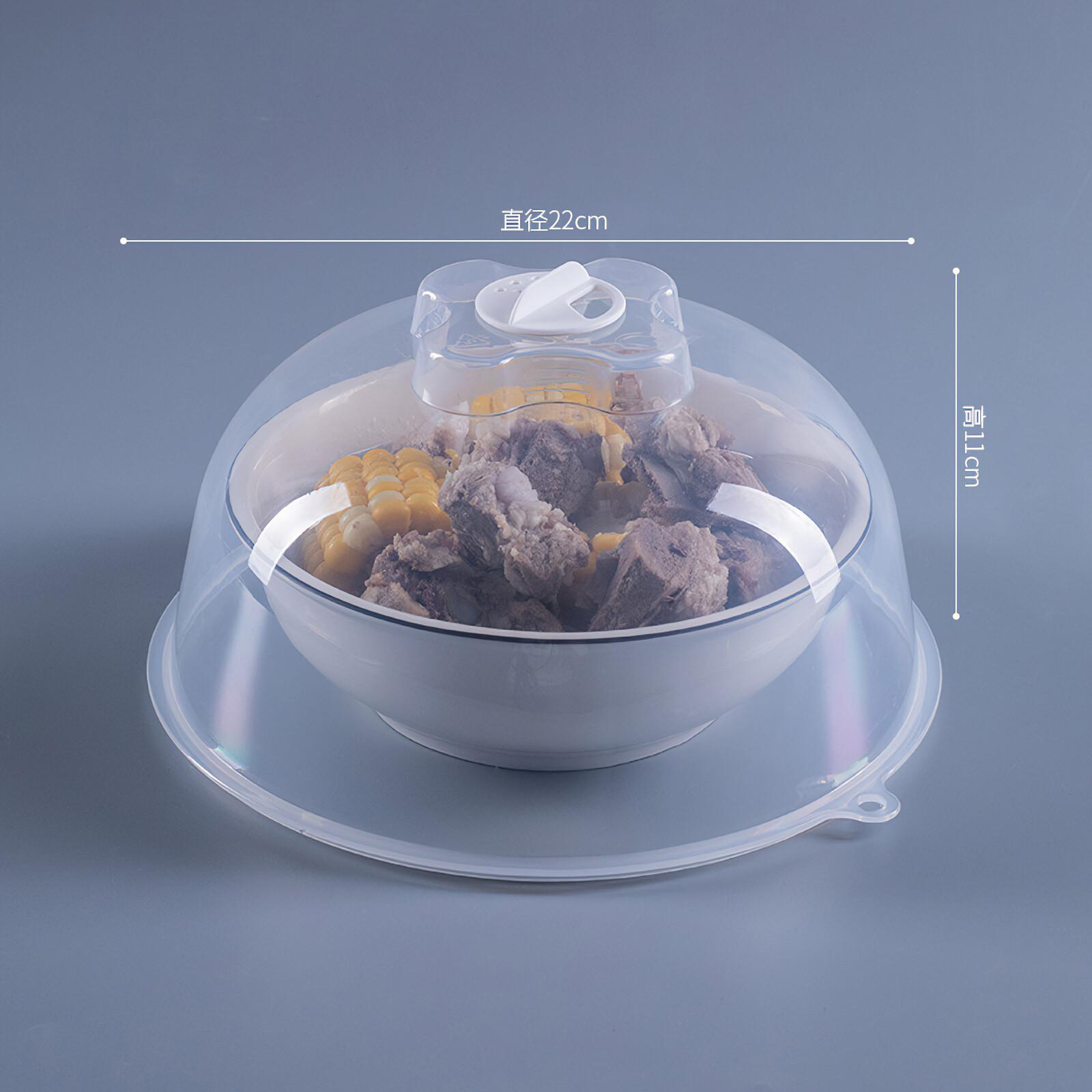 Eine Schüssel mit Essen, bedeckt von einem durchsichtigen Plastikdeckel. Enthält Mais und Fleisch. Grauer Hintergrund.