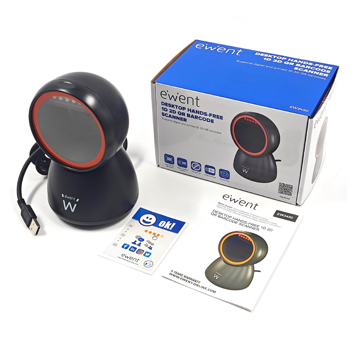 Uno scanner di codici a barre nero con anello rosso, scatola e fogli su superficie bianca.