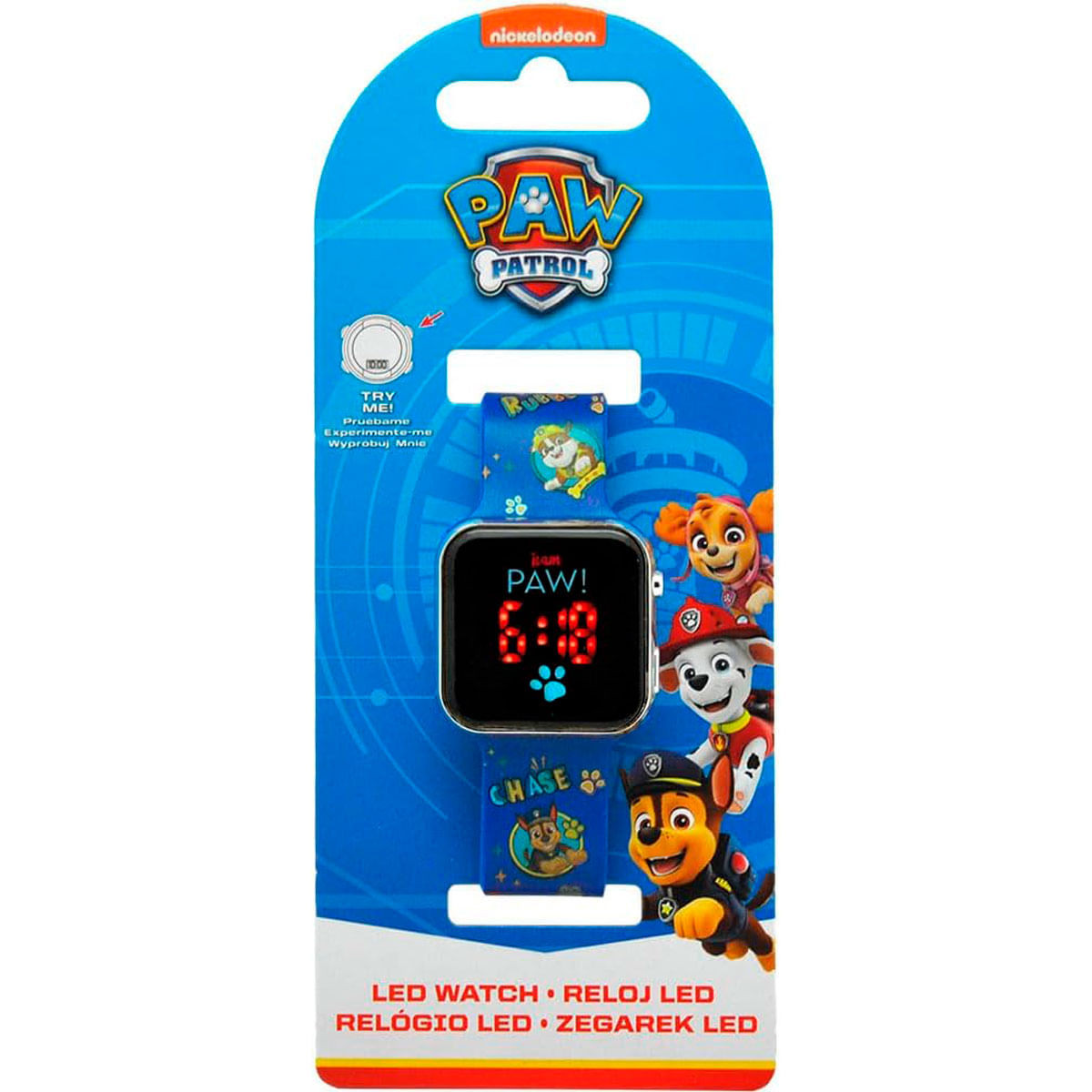 Un reloj LED de Paw Patrol en un embalaje azul. La esfera del reloj muestra las 6:18. Se muestran los personajes Chase, Skye, Rubble y Marshall.