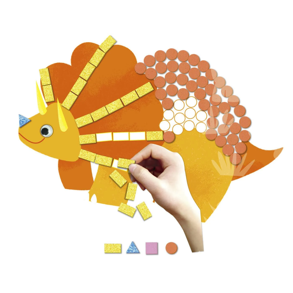 Una mano coloca un rectángulo amarillo brillante sobre una ilustración de triceratops, que es naranja y amarillo. Hay varias formas presentes.