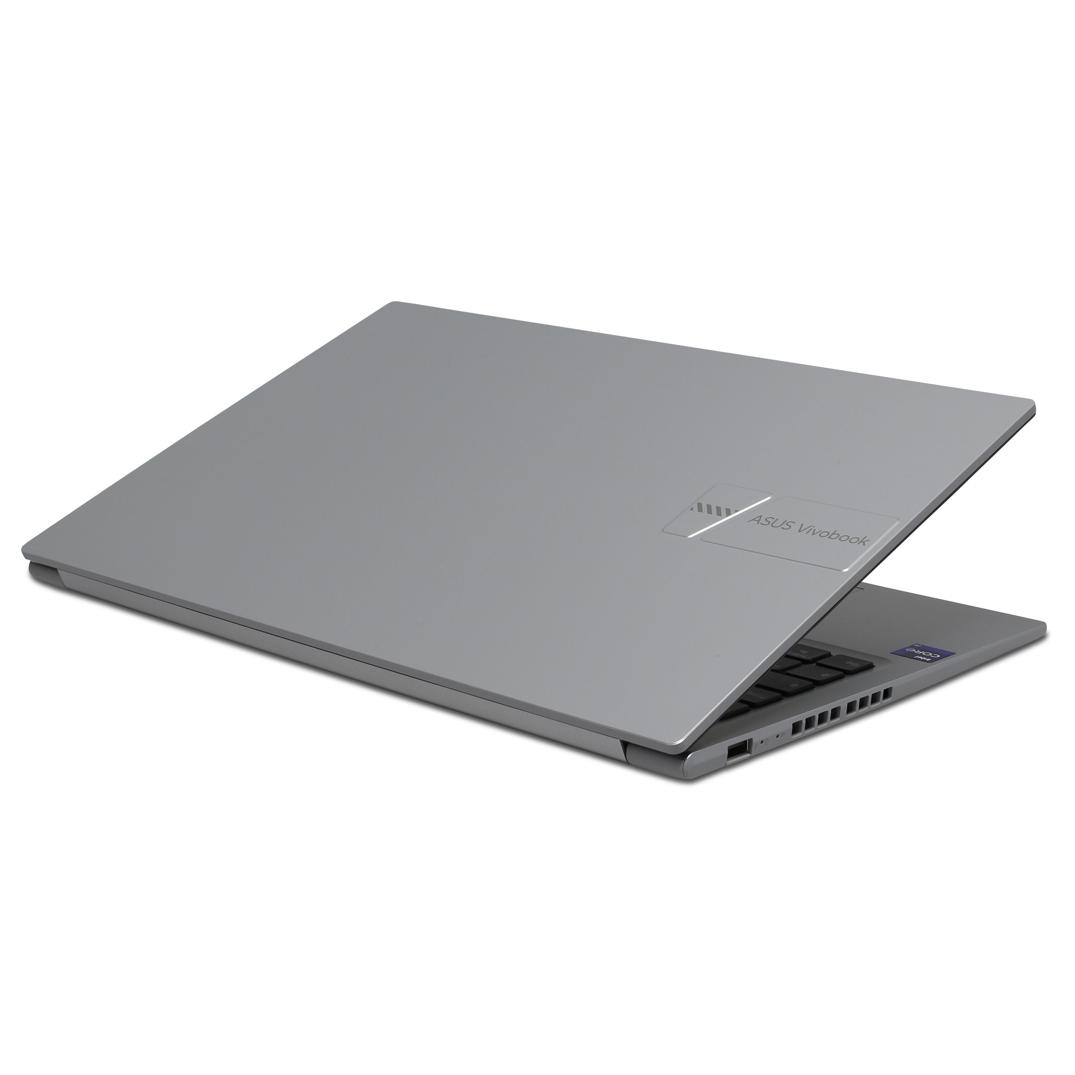 Portátil ASUS Vivobook gris ligeramente abierto sobre una superficie blanca. Teclado y logo visibles.