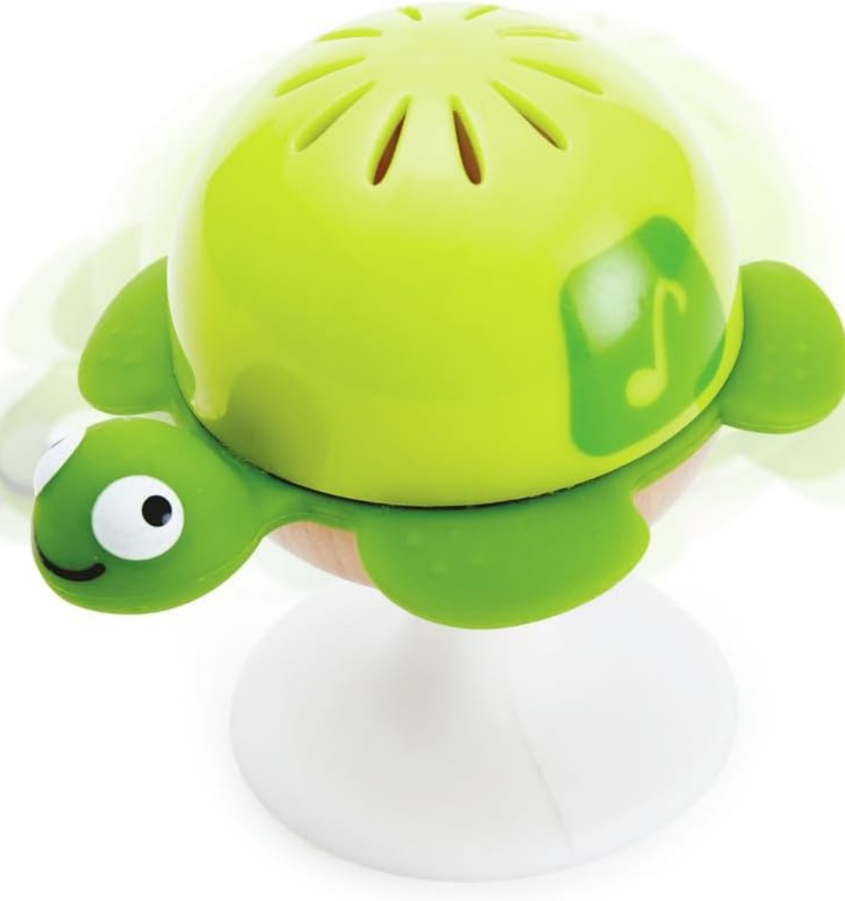 Ein grünes, schildkrötenförmiges Spielzeug mit weißem Sockel. Die Schildkröte hat einen runden Kopf, eine Note und lächelnde Augen.
