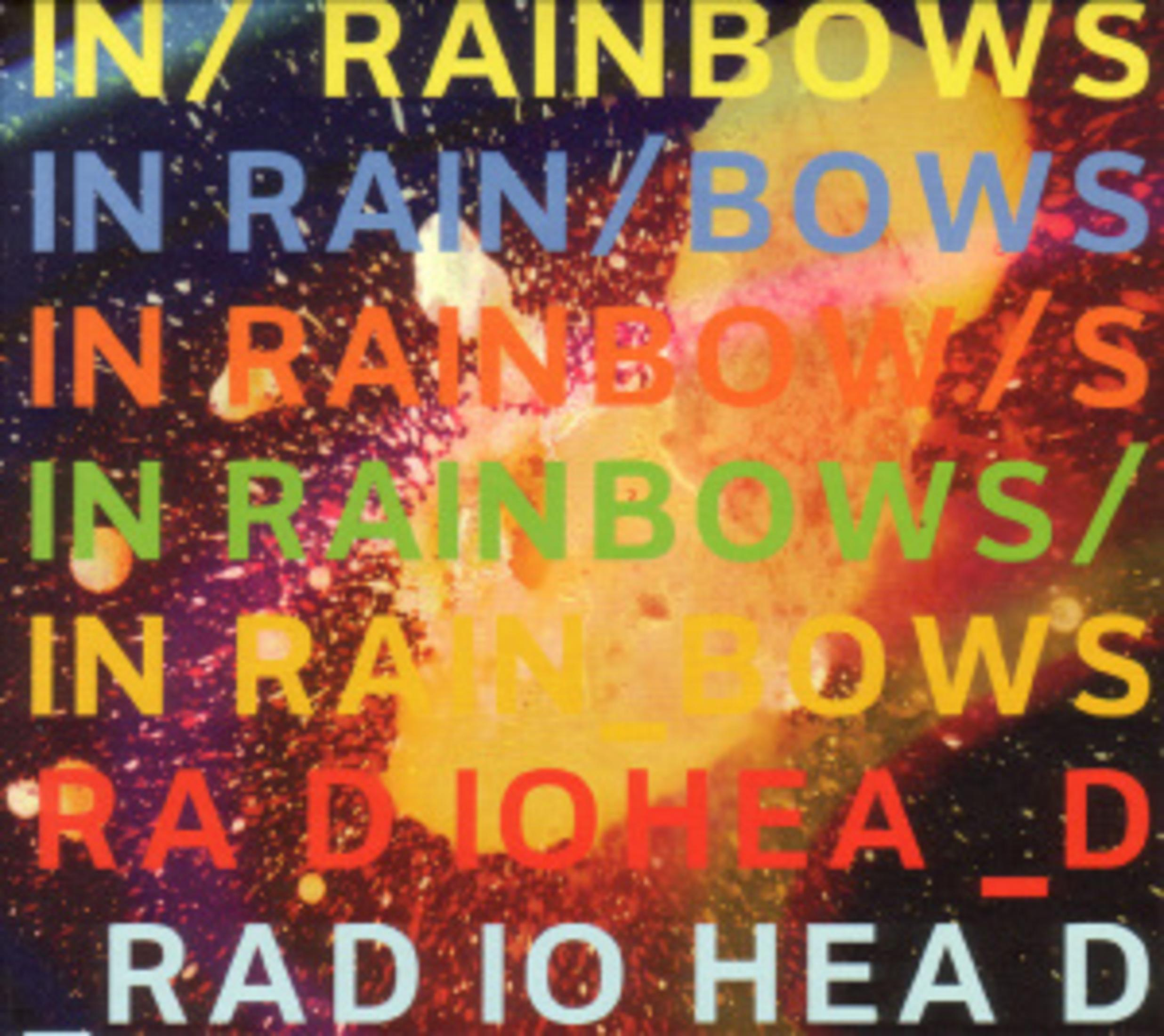 Albumcover mit dem Text "IN RAINBOWS" in verschiedenen Farben auf einem gesprenkelten Hintergrund und "RADIO HEAD".