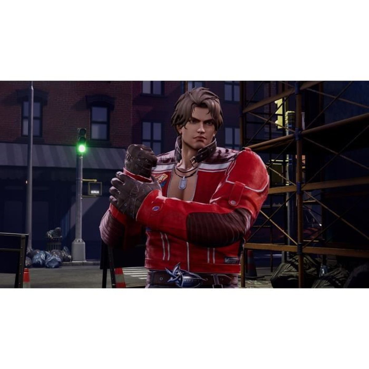 Mężczyzna w czerwonej kurtce stoi na ulicy. Widoczny jest sygnalizator świetlny. Budynki i rusztowania w tle.