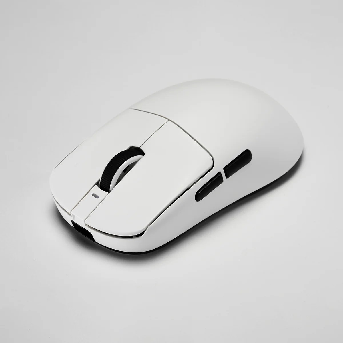 A white computer mouse. It has a scroll wheel, two side buttons, and a sleek design against a white background.