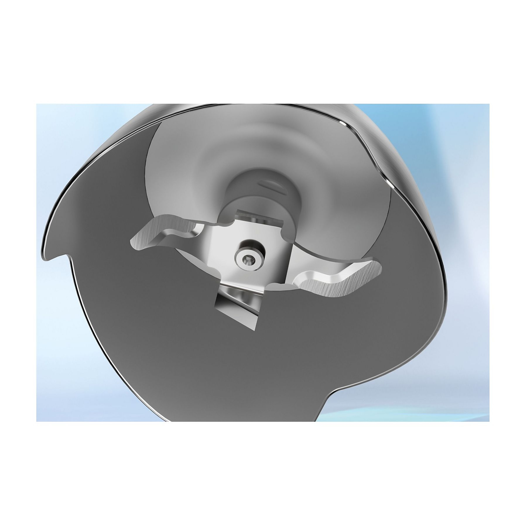 Zbliżenie zespołu ostrzy blendera. Ostrza są srebrne i zamknięte w szarej, metalowej obudowie na niebieskim tle.