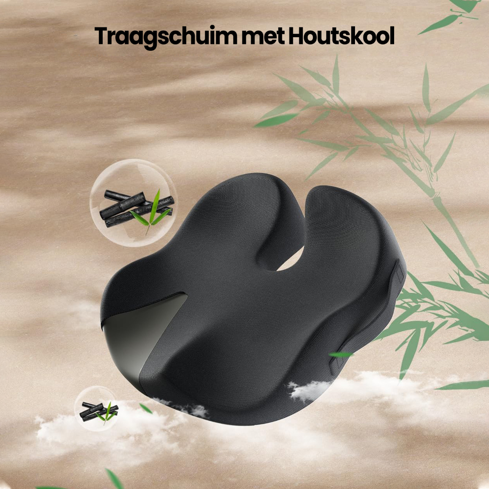 A dark gray ergonomic cushion with a cutout. Charcoal and bamboo sprigs are in bubbles. The background is light brown with bamboo.