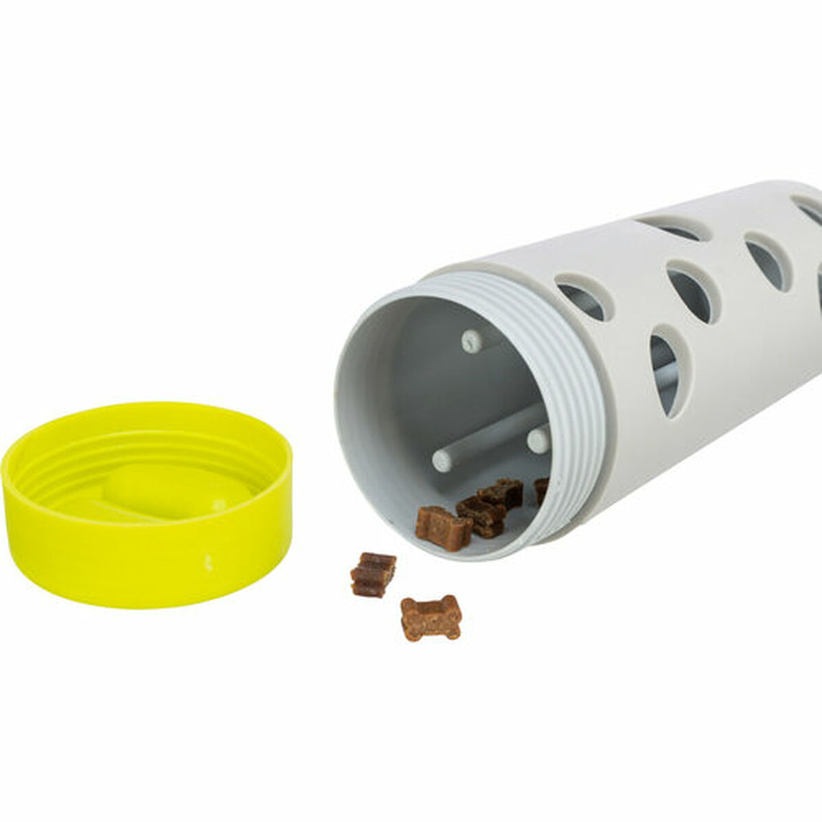 A gray plastic pet toy with holes and an open lid. Small brown treats are spilling out. A yellow lid is nearby.