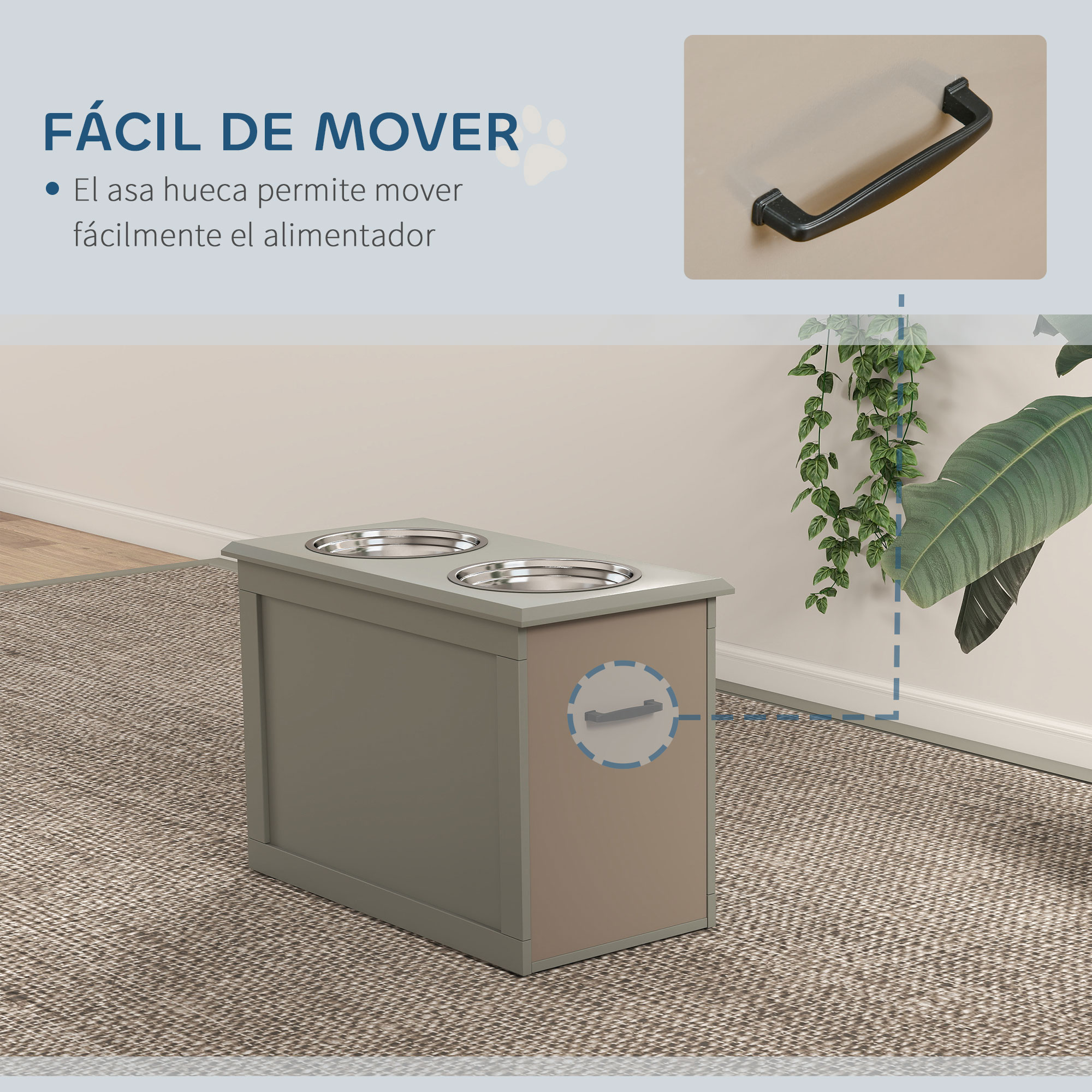 Un comedero gris para mascotas con dos cuencos de acero inoxidable. Tiene un asa y está sobre una alfombra. Plantas en el fondo.