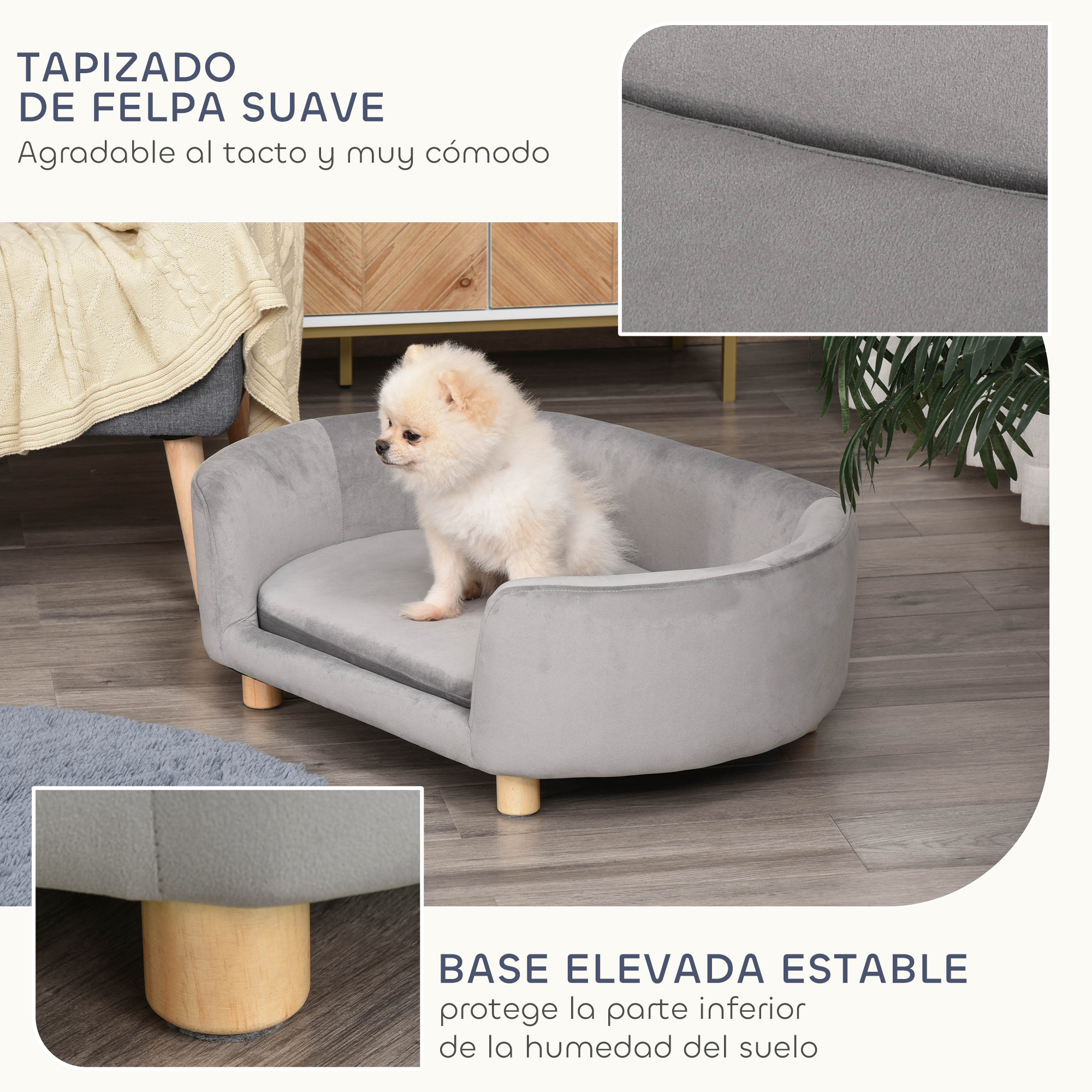 Un perro pequeño está sentado en una cama gris para mascotas. La cama tiene patas de madera. El fondo muestra piso de madera y hojas verdes.