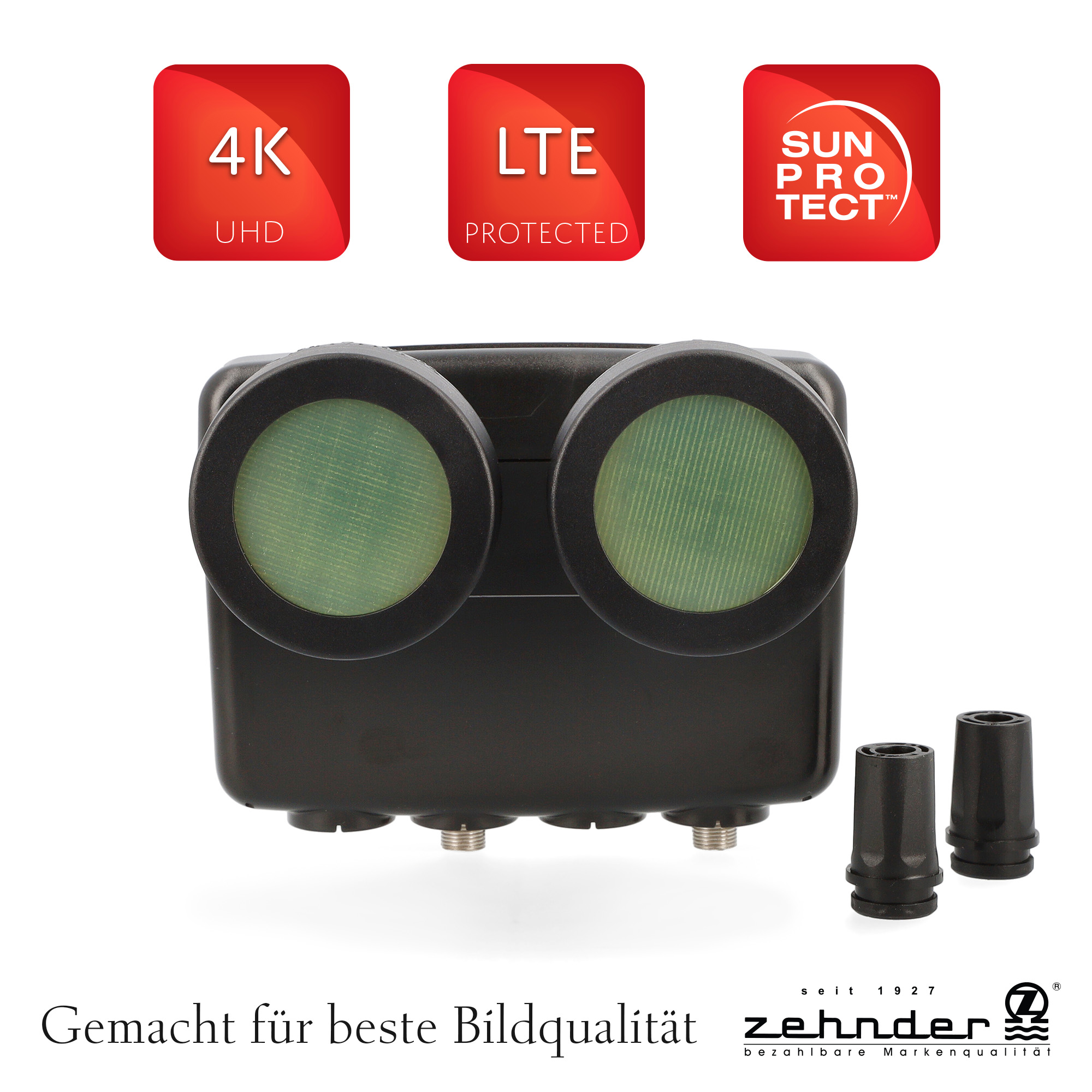 Ein schwarzes Gerät mit zwei großen Linsen, drei roten Quadraten mit weißem Text und zwei schwarzen Düsen.