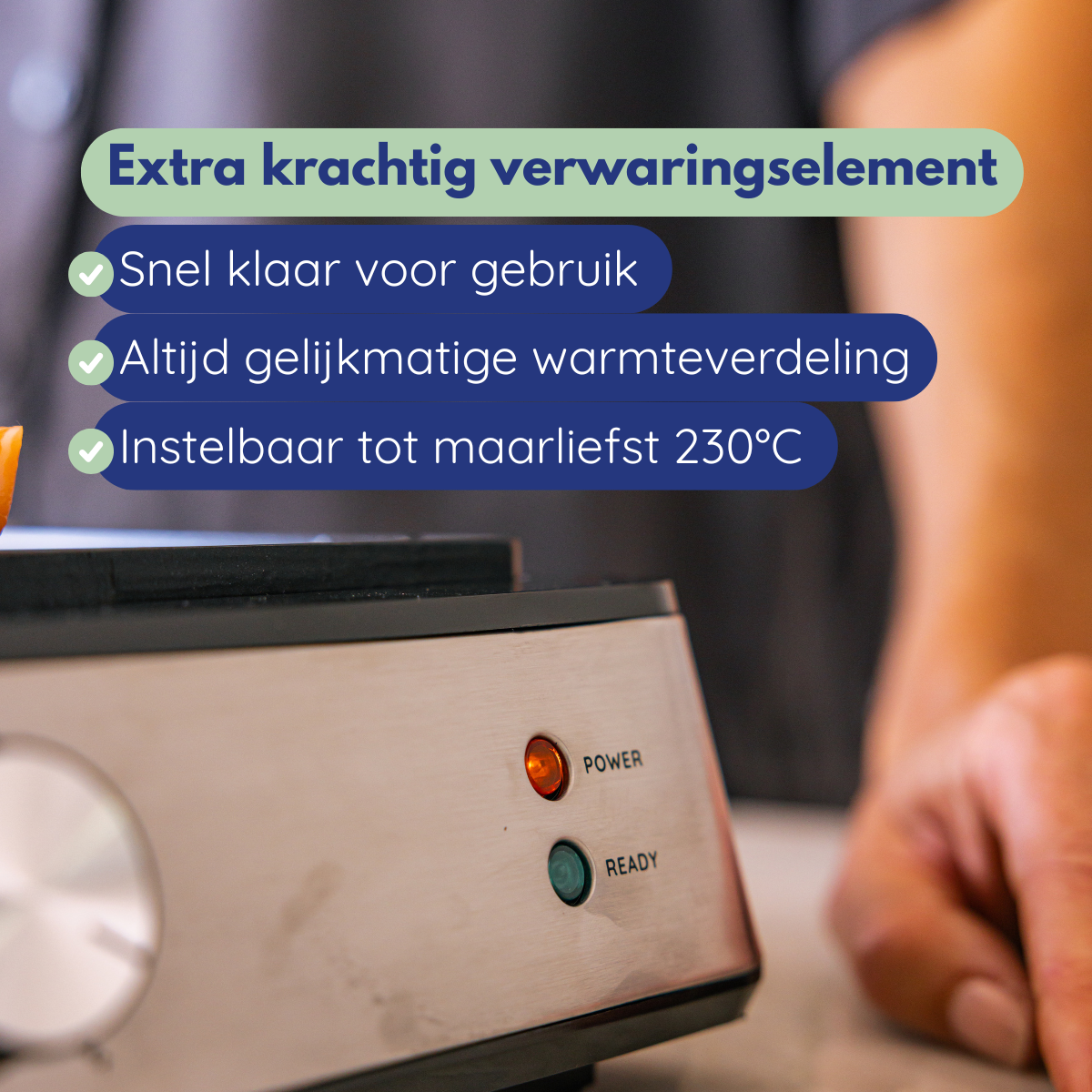 A close-up of a silver appliance with illuminated power and ready lights. Text says: extra powerful heating element.