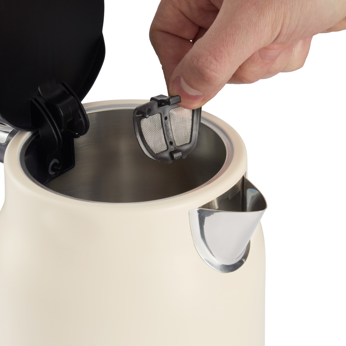 Eine Hand setzt einen schwarzen Filter in einen cremefarbenen Wasserkocher ein. Der Deckel des Wasserkochers ist offen.