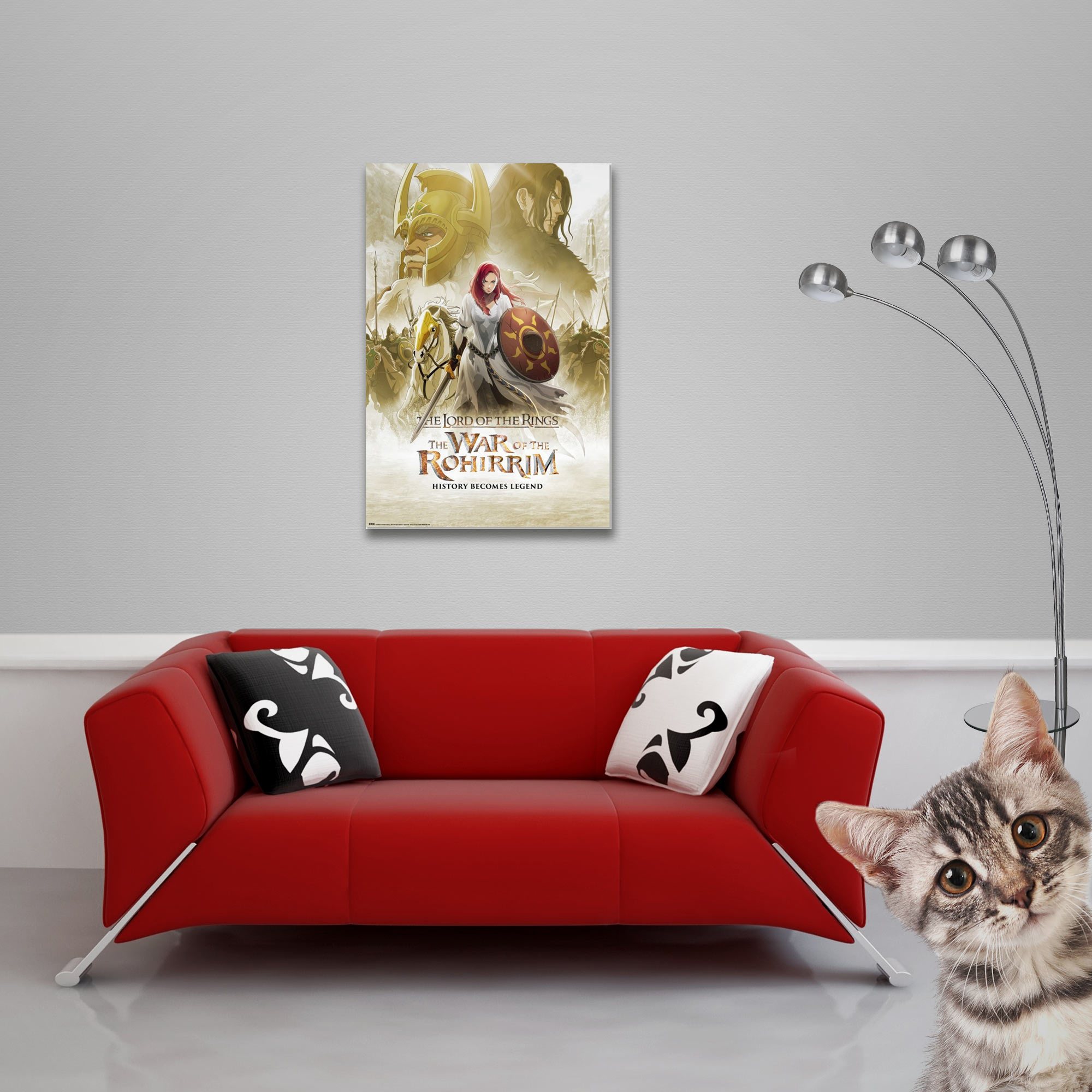 Ein rotes Sofa mit Kissen. Ein Poster an der Wand. Eine Lampe und eine Katze sind ebenfalls im Raum zu sehen.
