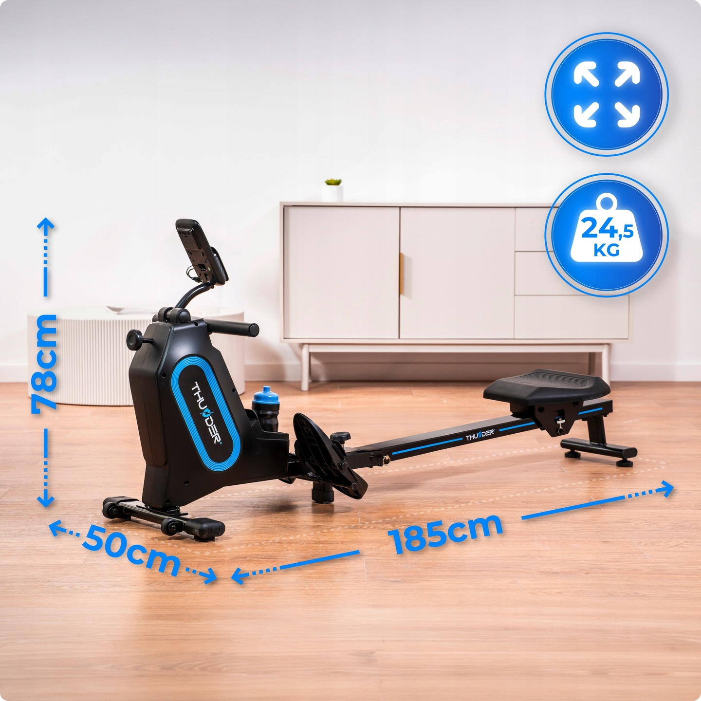 Wioślarz o wymiarach: 185cm długości, 78cm wysokości, 50cm szerokości. Waga 24,5kg. Kolory niebieski i czarny. Białe tło.