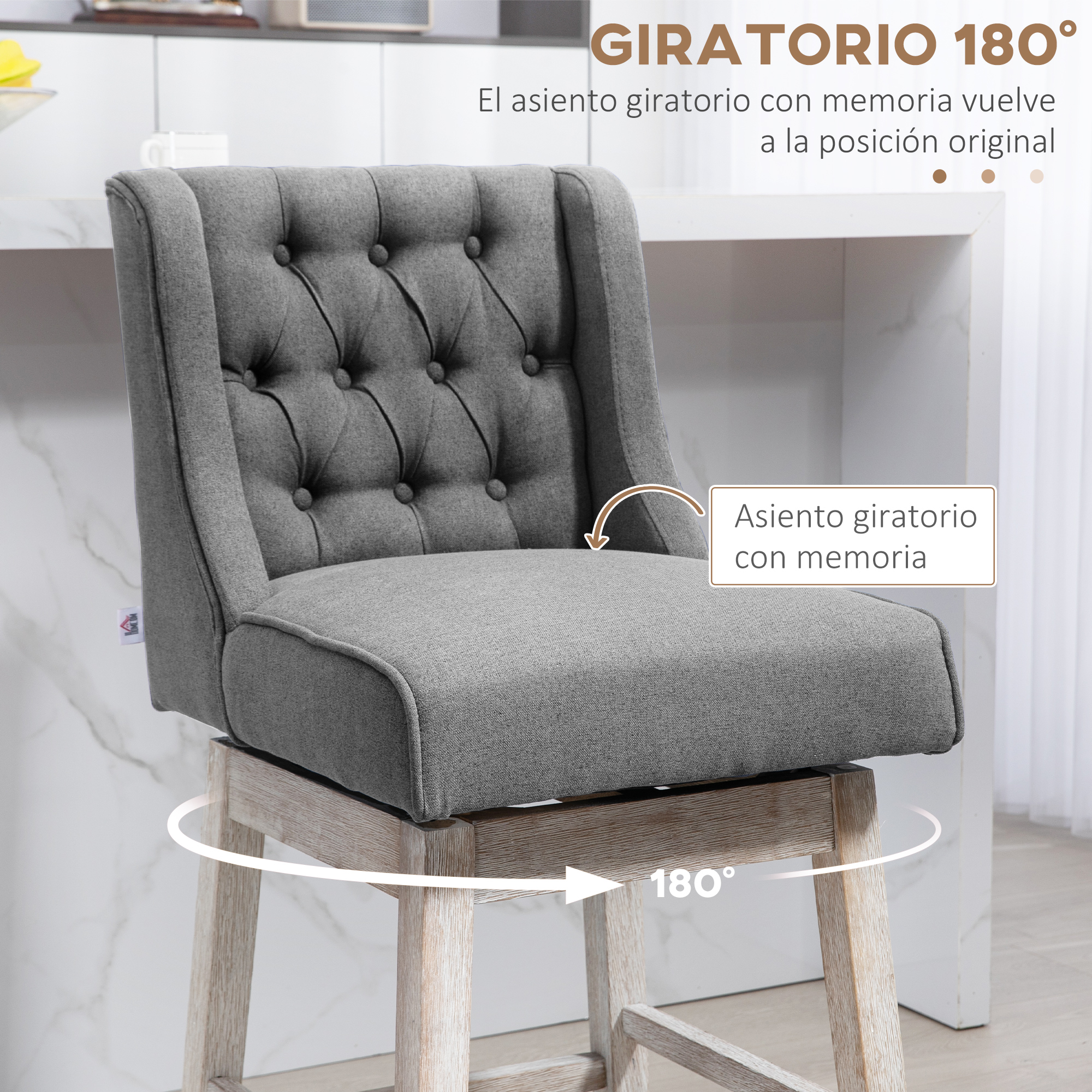 Una silla giratoria gris con respaldo acolchado. La silla gira 180 grados. Tiene base de madera y está en un ambiente de cocina.