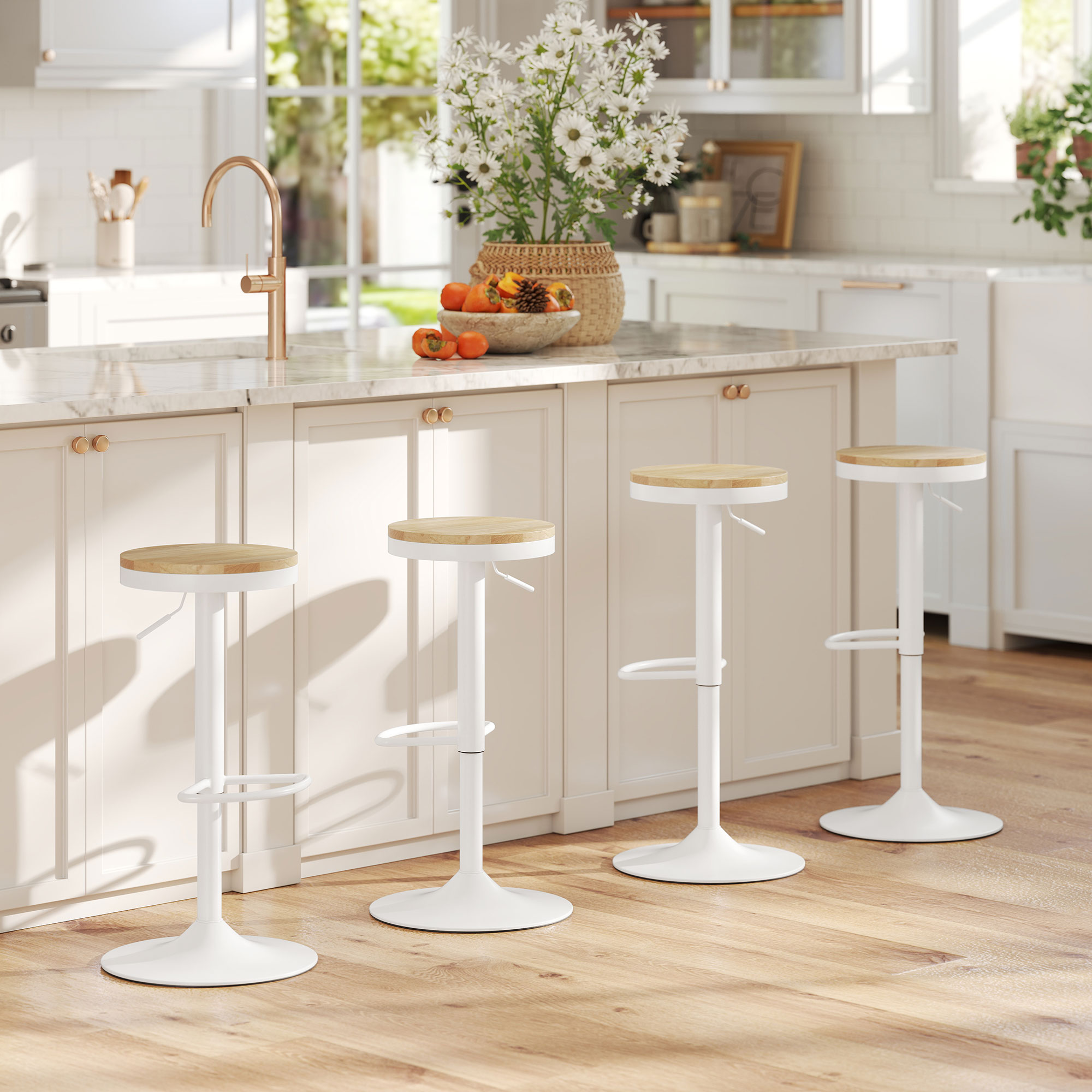 Cocina con gabinetes blancos, cuatro taburetes y un fregadero. Flores y fruta en la encimera. Suelo de madera clara.