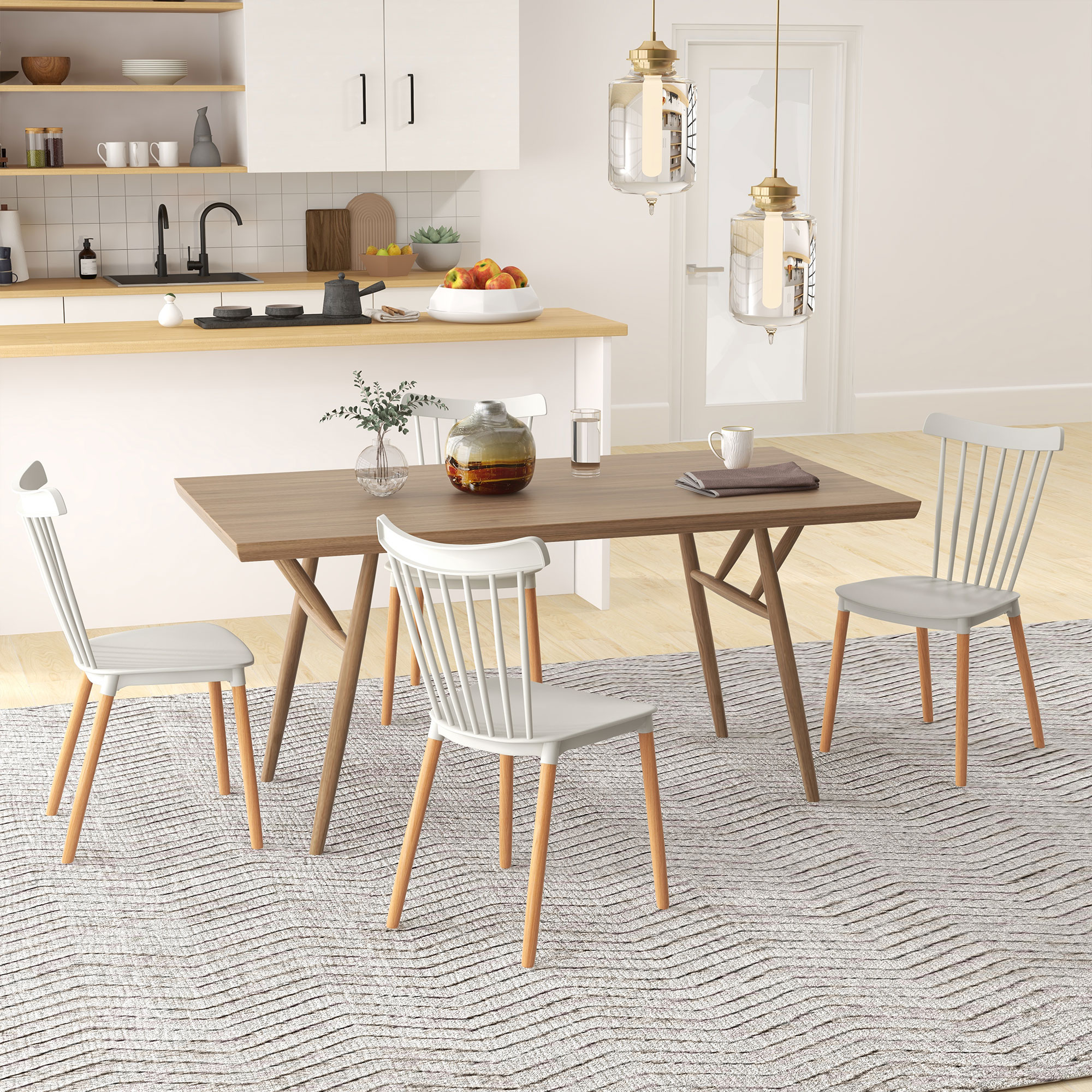 Escena de comedor con mesa de madera, cuatro sillas y alfombra. Cocina al fondo. Dos luces colgantes.