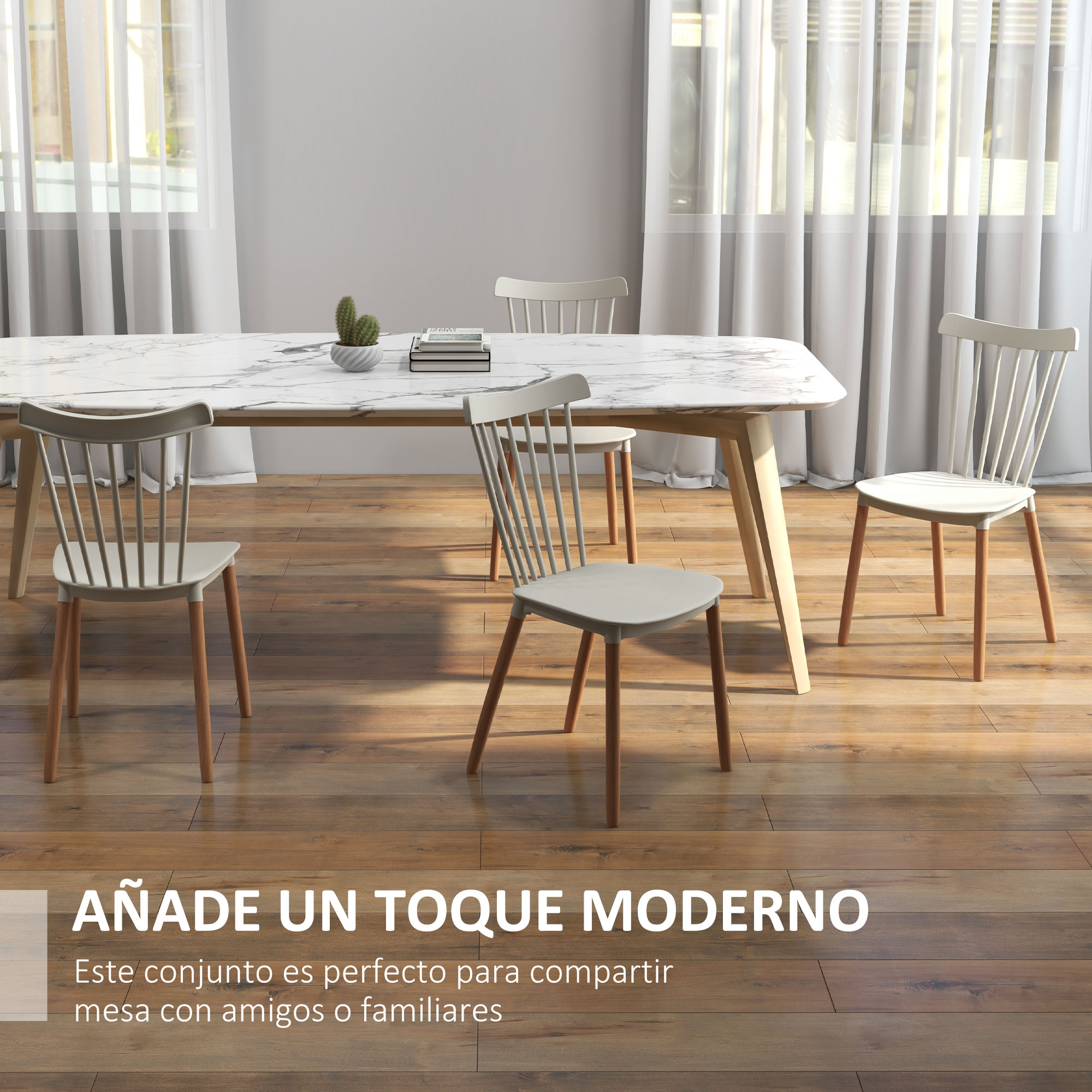 Juego de comedor con mesa de mármol y cuatro sillas. Un cactus y libros sobre la mesa. Suelo de madera.