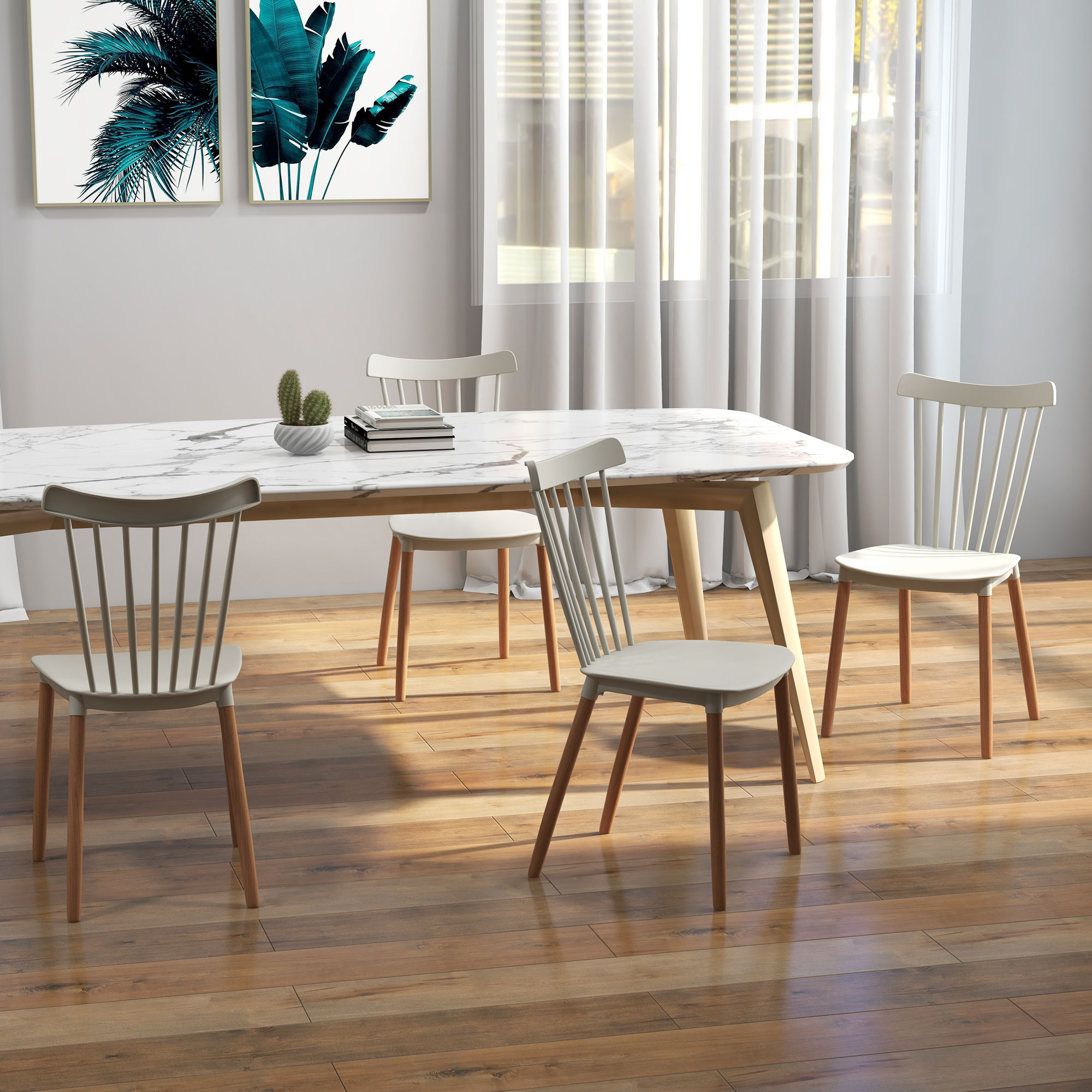 Un comedor con una mesa de mármol blanco y cuatro sillas. También se ven obras de arte en la pared y una ventana con cortinas.