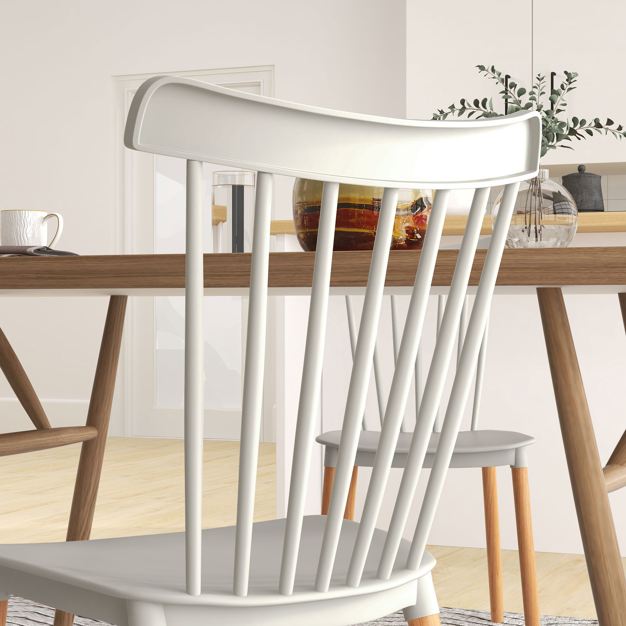Una silla blanca con respaldo curvo está en foco. Una mesa, vaso y elementos decorativos son visibles en el fondo.