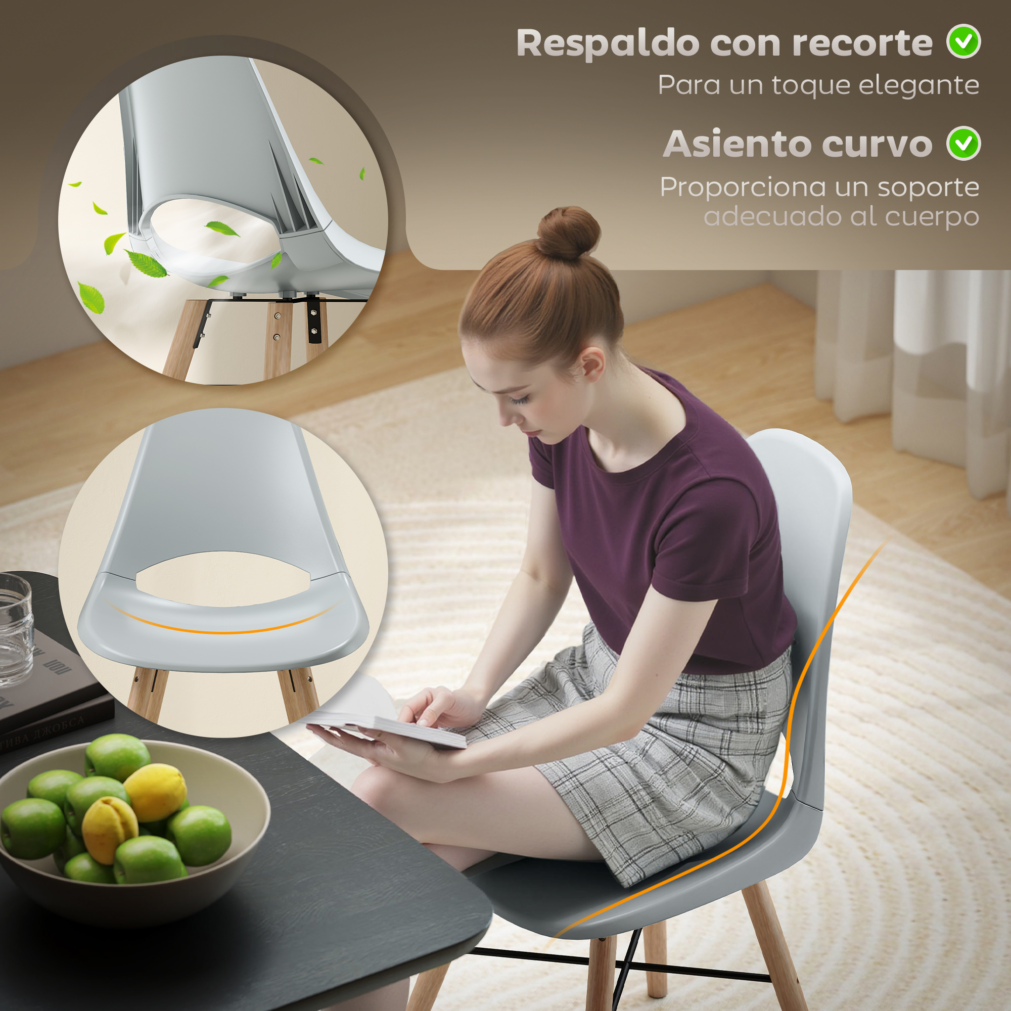 Una mujer sentada en una silla gris, sosteniendo un libro. Un cuenco de fruta y un libro sobre una mesa.