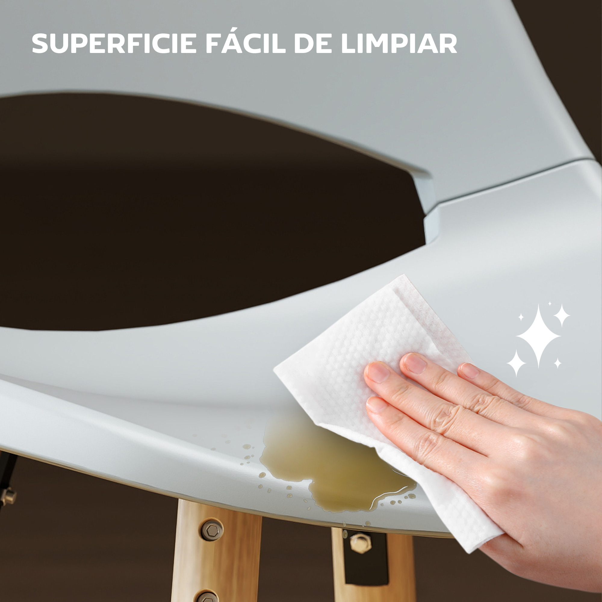 Una mano limpia un derrame de una superficie blanca. Arriba dice: superficie fácil de limpiar. Se ven las patas de madera de una silla.