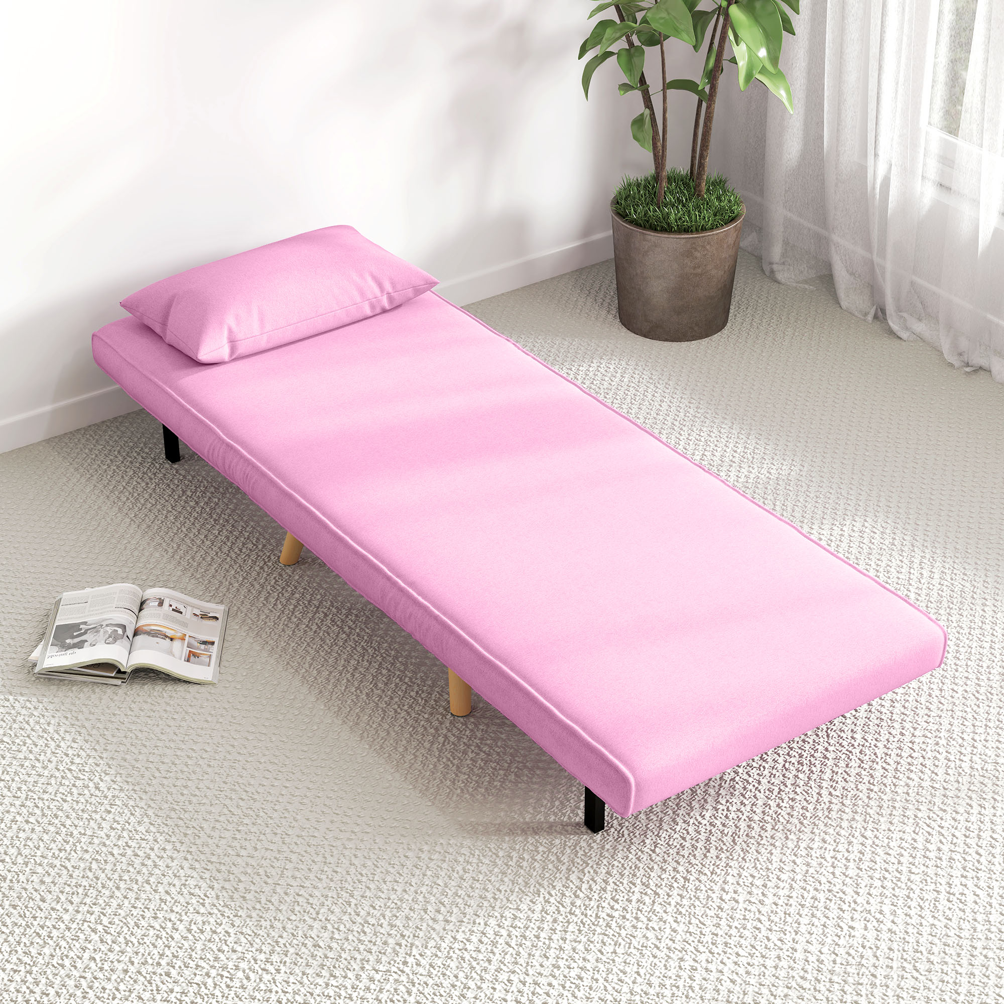 Sofá cama rosa con almohada, libro abierto y planta en maceta sobre alfombra blanca.