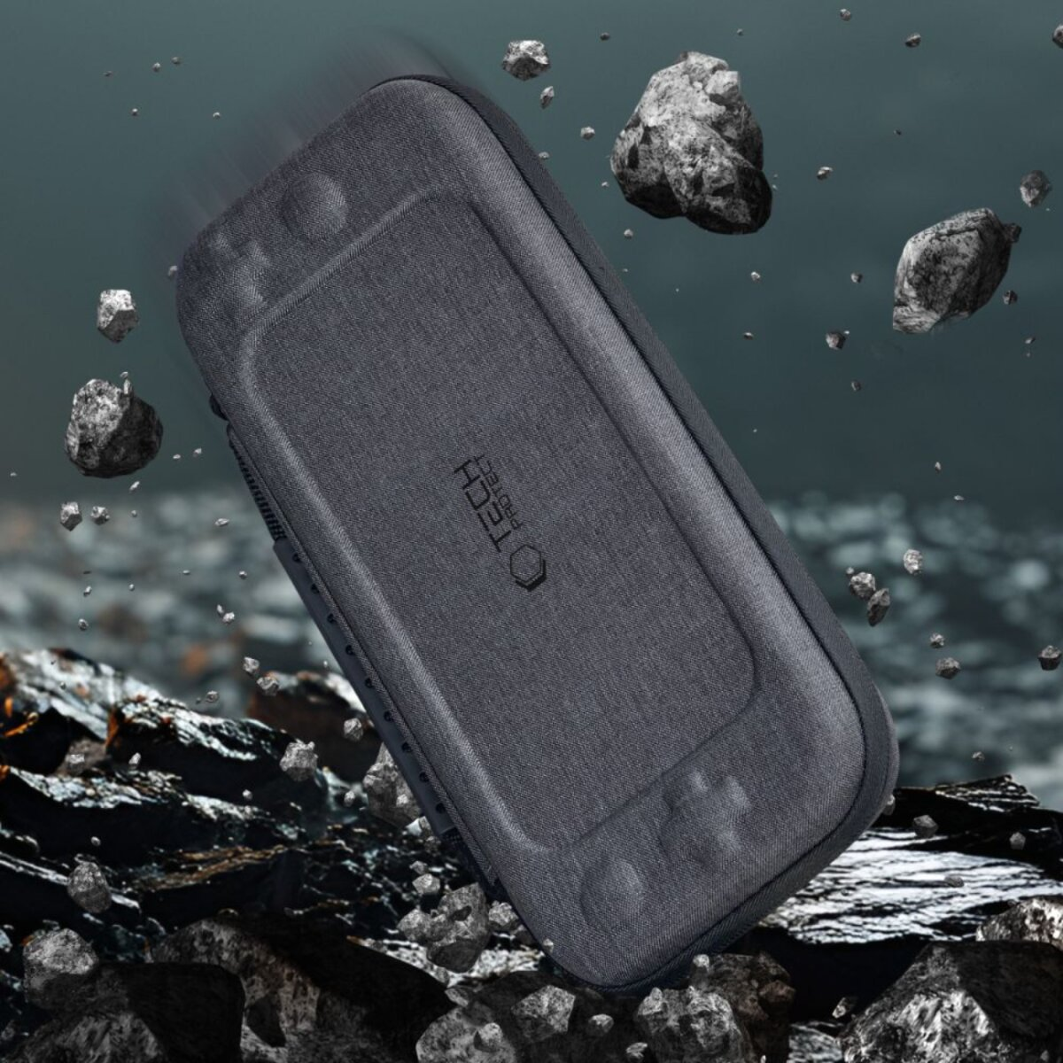 A gray case with 'TECH PROTECT' text is surrounded by floating rocks. The case has a game console shape with buttons.