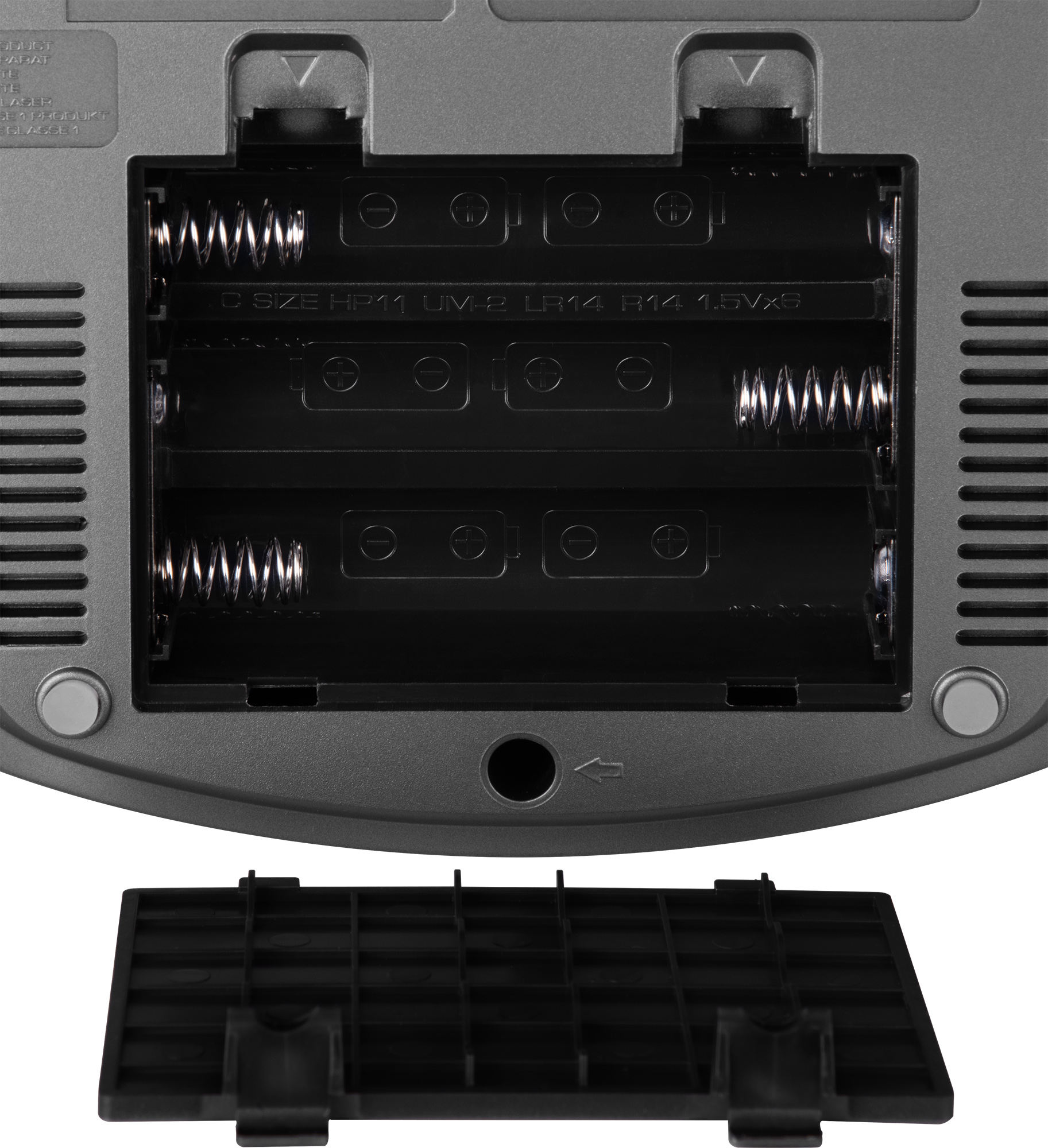 Offenes Batteriefach, grauer Kunststoff. Enthält Schlitze für Batterien und Metallfedern. Schwarze Abdeckung unten abgenommen.