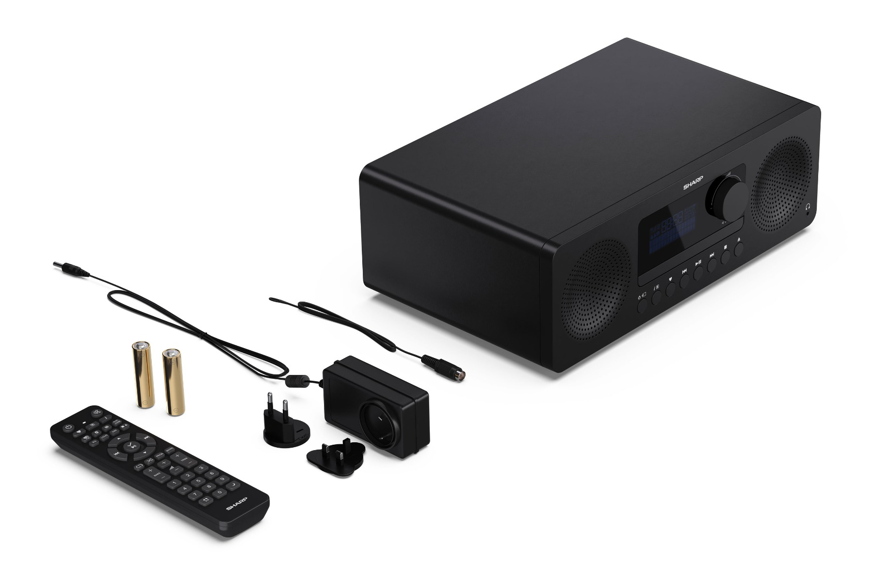 Black radio with accessories: remote, batteries, power adapters. Radio has speakers and display. All on white background.