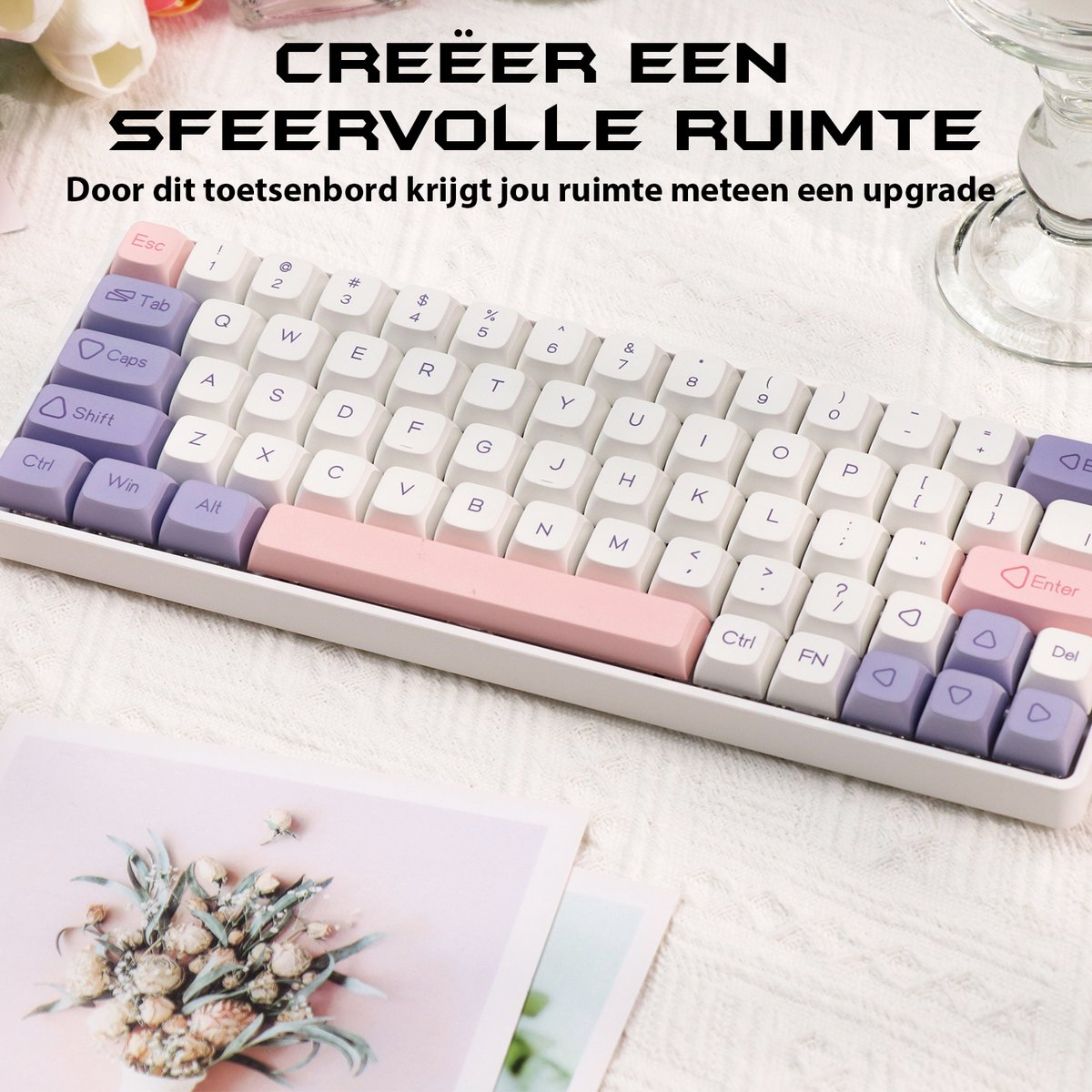 A white and purple keyboard on a white surface with text in Dutch. Flowers and a glass are also visible.