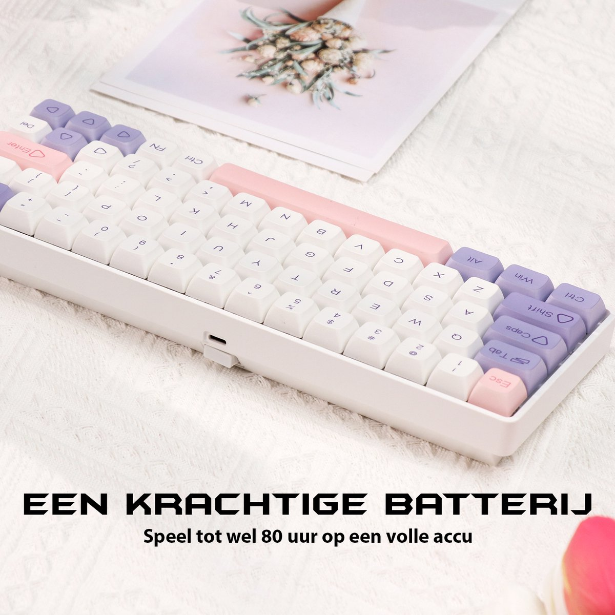 A white and pastel keyboard on a white surface. It has white, pink, and purple keys. Text at the bottom: A powerful battery.