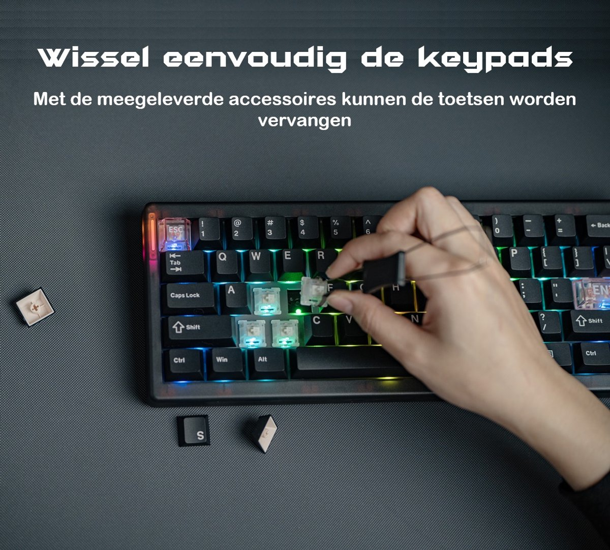 A hand is using a tool to remove a keyboard key. The keyboard is black with colorful lights. Several keys are off the keyboard.