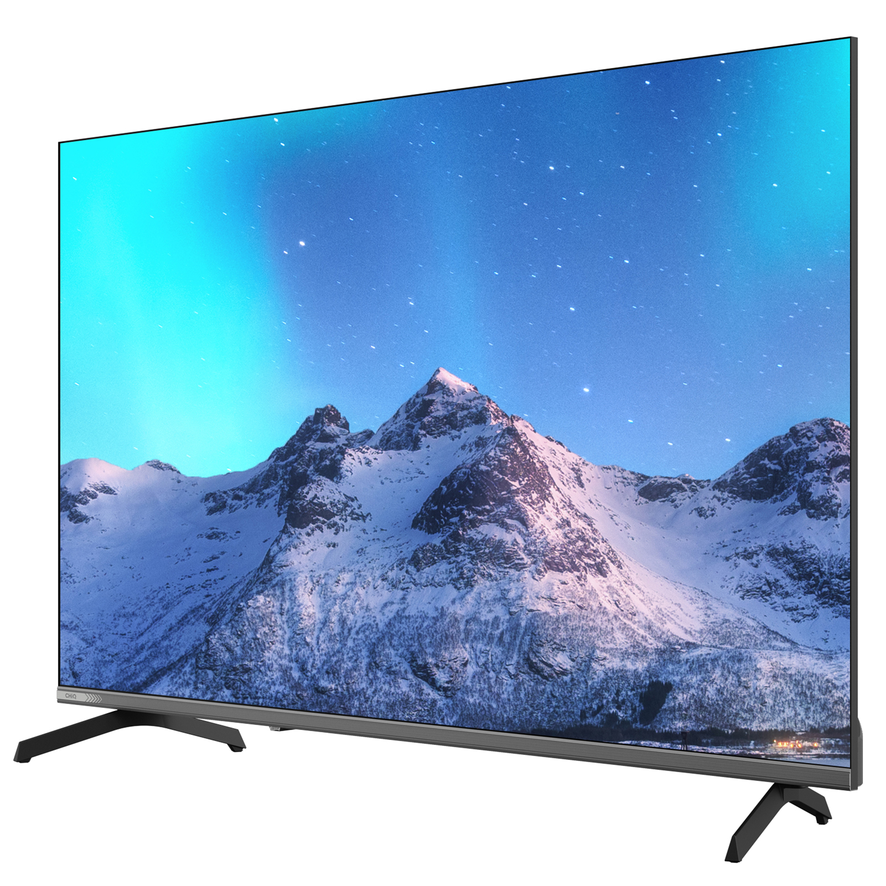 A TV displays a snowy mountain scene with stars and aurora borealis. The TV has black legs and a dark frame.