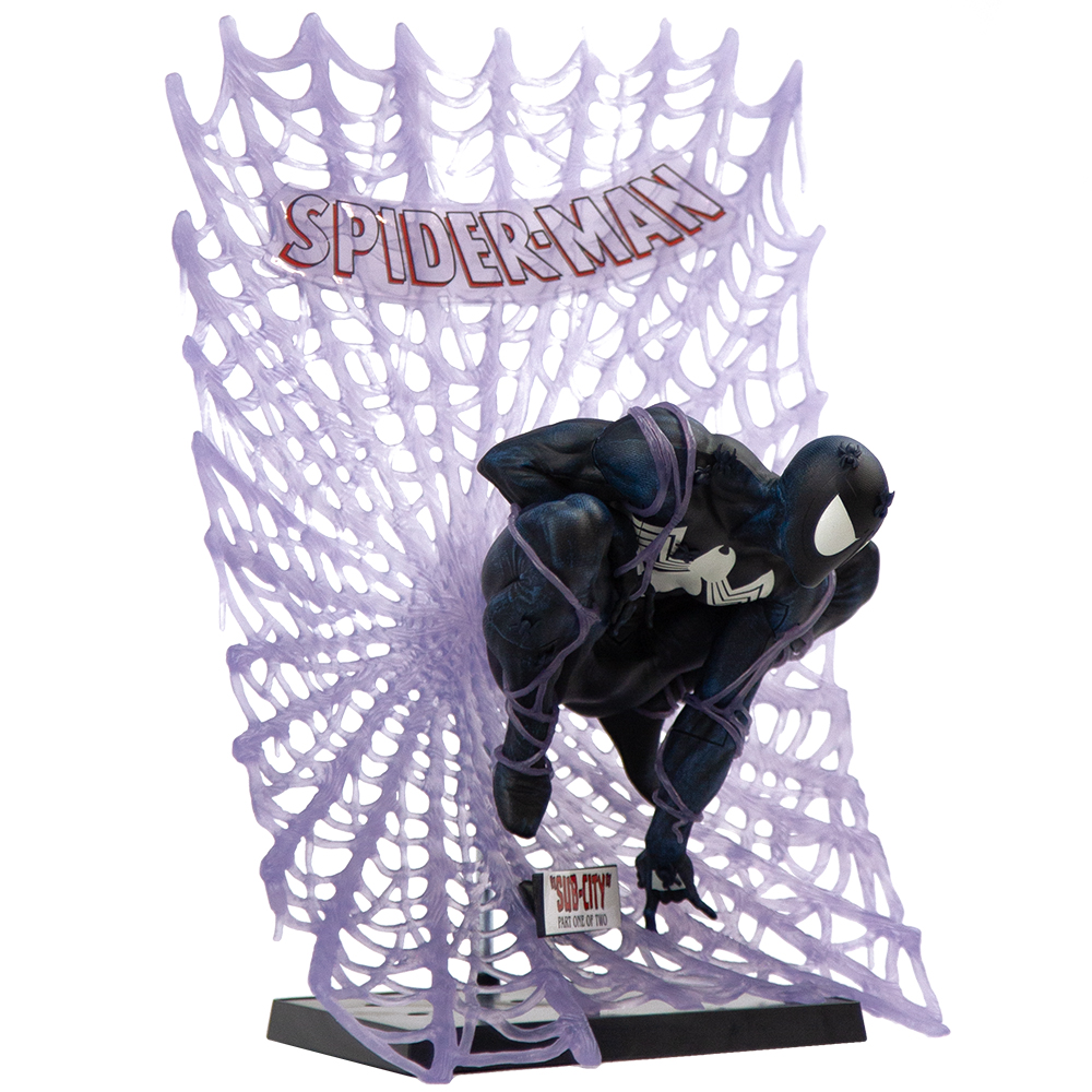 Una statuetta di Spider-Man in posizione accovacciata, con uno sfondo di ragnatela viola e la scritta 'Spider-Man'.