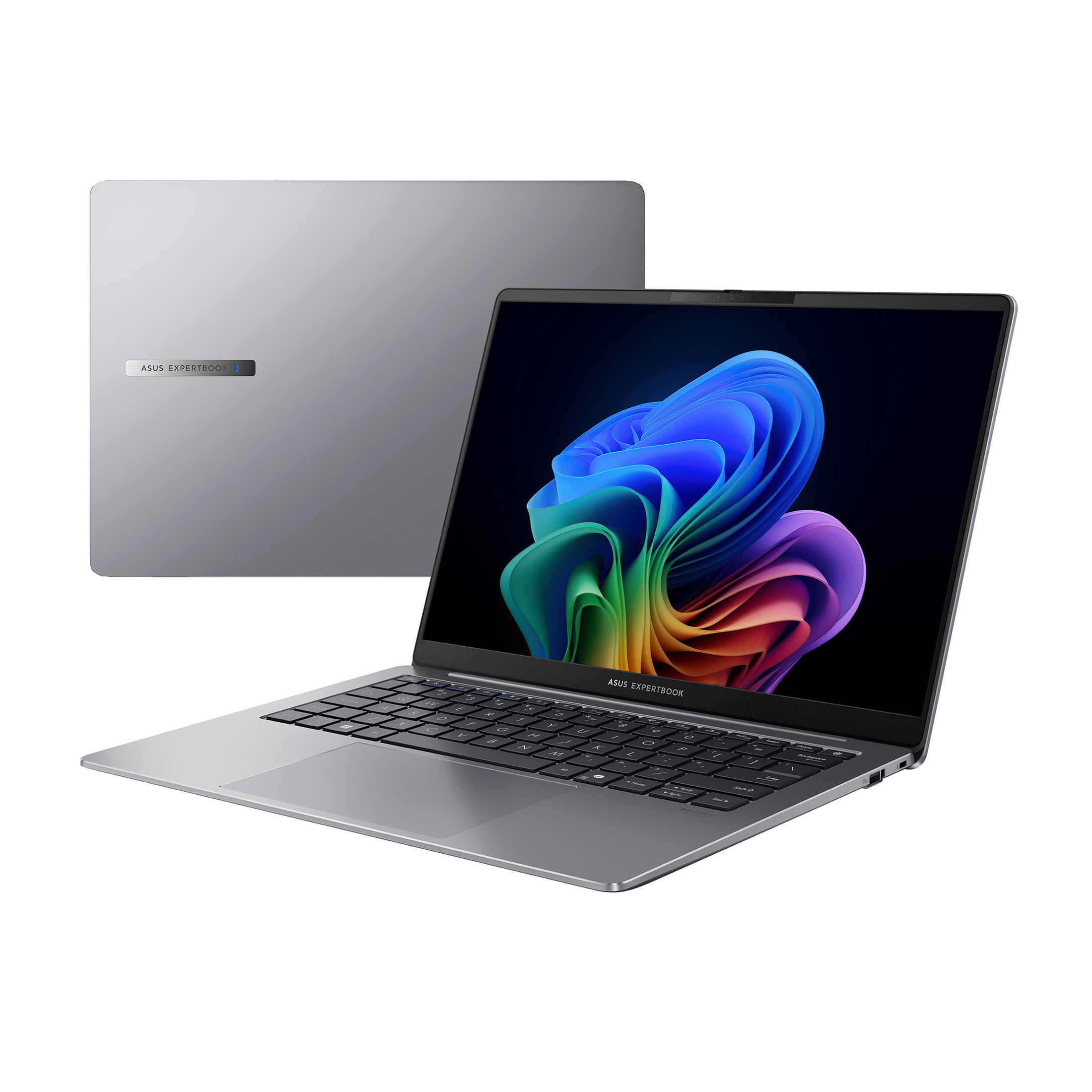 Ein silbernes Asus Expertbook-Laptop wird offen angezeigt. Der Bildschirm zeigt ein farbenfrohes abstraktes Bild. Ein weiteres Laptop ist dahinter.