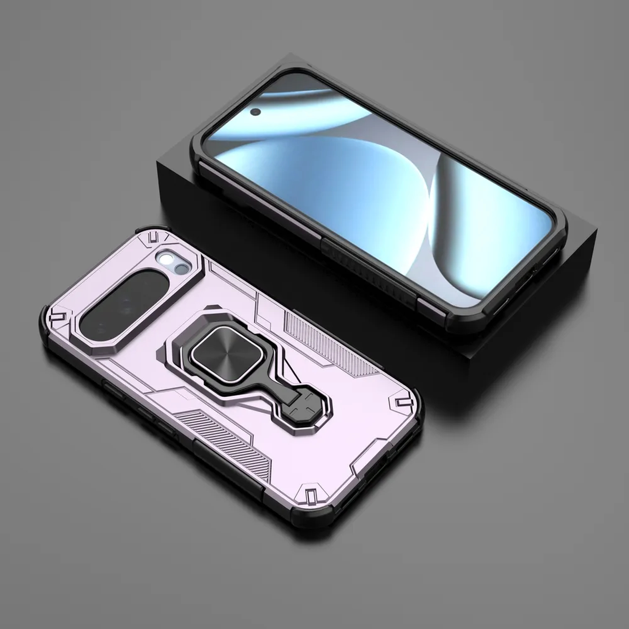 Twee telefoonhoesjes. Eén roze met een ringhouder, de andere zwart. Beide op een donker oppervlak.