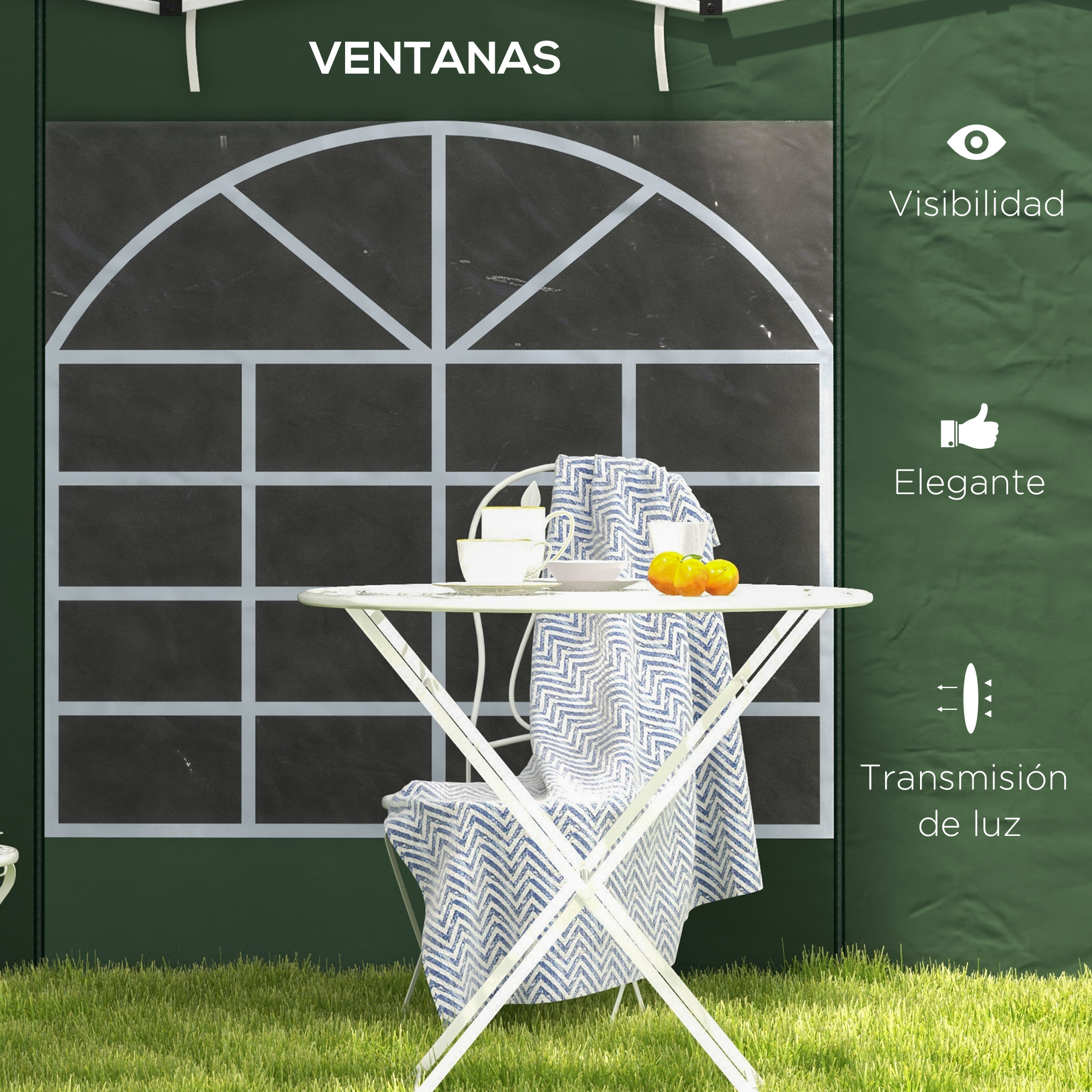 Una mesa blanca con tazas, una silla y una tela azul estampada se encuentra frente a una ventana. Hay naranjas en la mesa.
