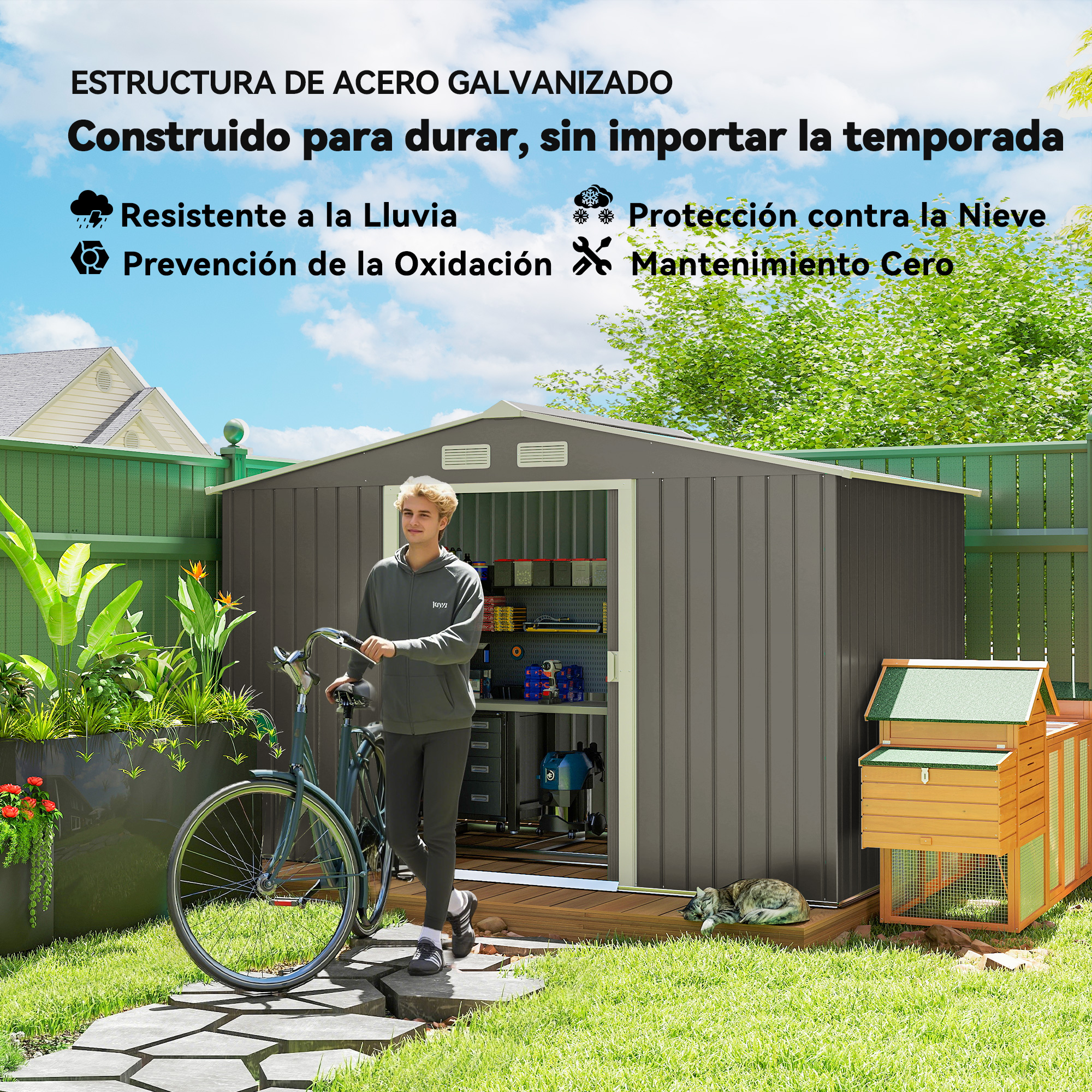 Un hombre con una bicicleta está junto a un cobertizo gris en un jardín. Un gato yace en la terraza de madera.