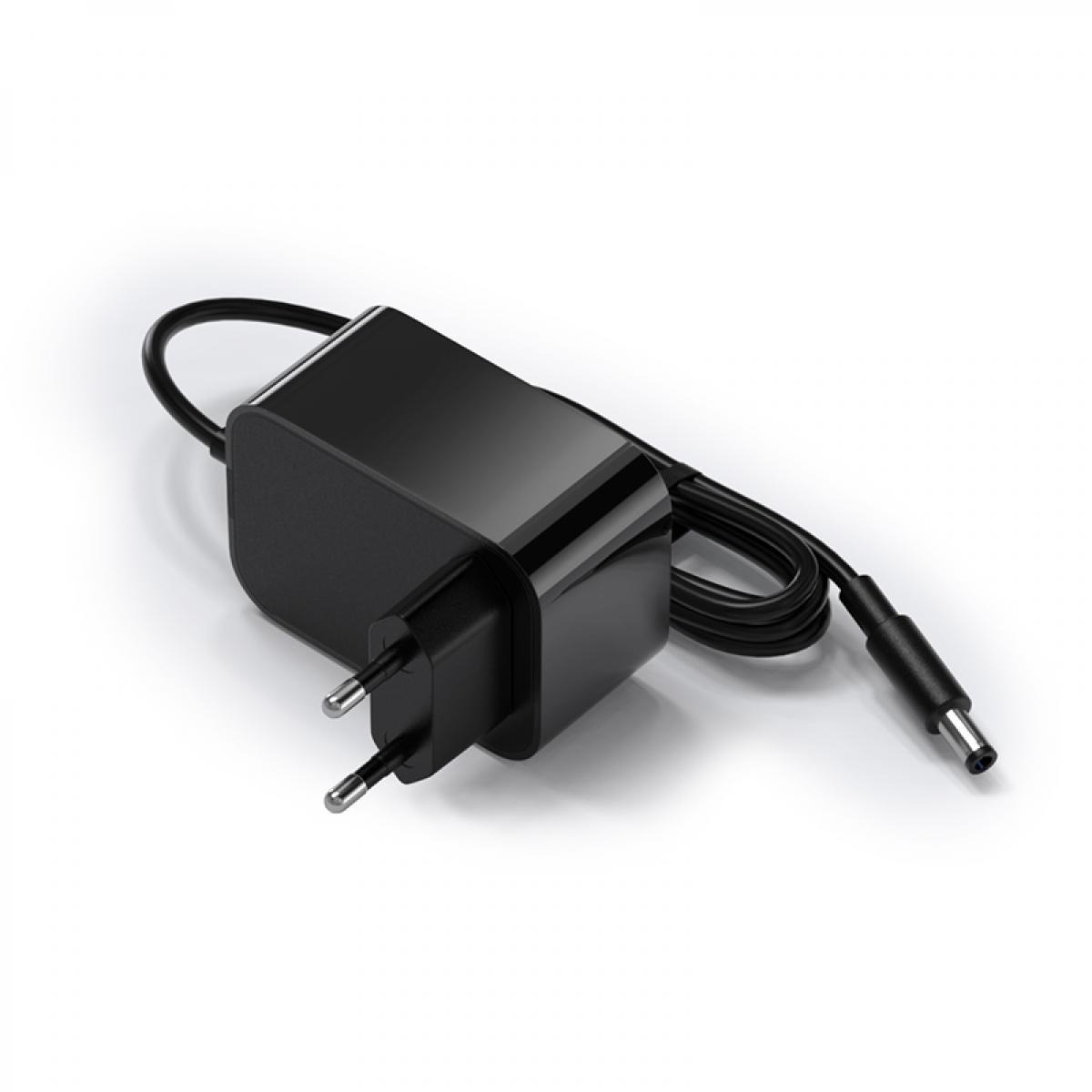 Ein schwarzes Laptop-Ladegerät mit einem Zweipol-Stecker und einem schwarzen Kabel. Es liegt auf einer weißen Oberfläche.