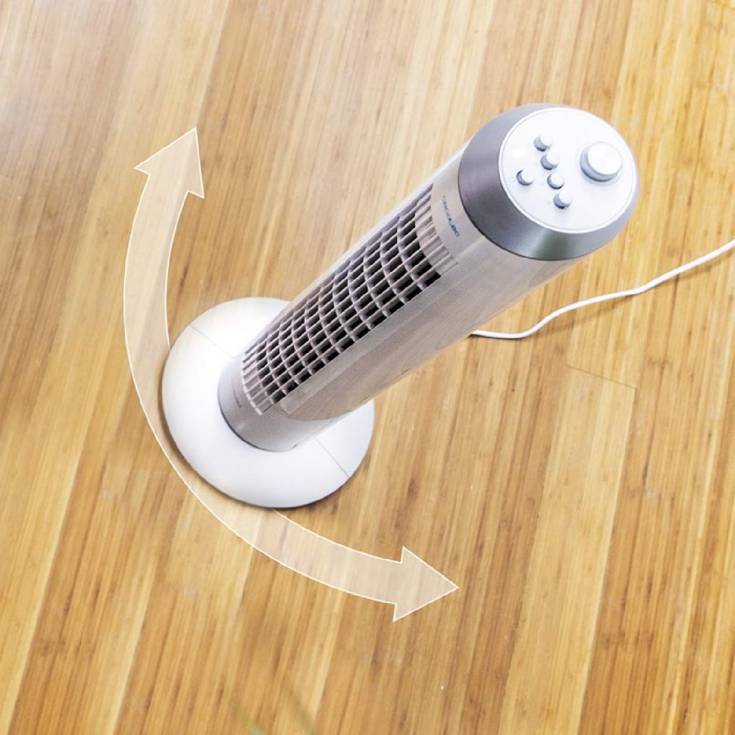 Wentylator wieżowy na drewnianej podłodze. Wentylator jest srebrny i biały. Strzałki wskazują na jego możliwy obrót.