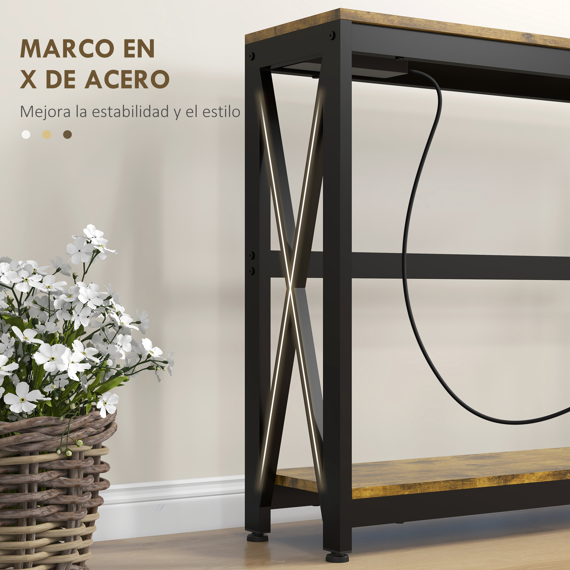Una mesa de metal con marco en forma de X. A la izquierda, una cesta con flores blancas. Un cable negro curva hacia abajo.