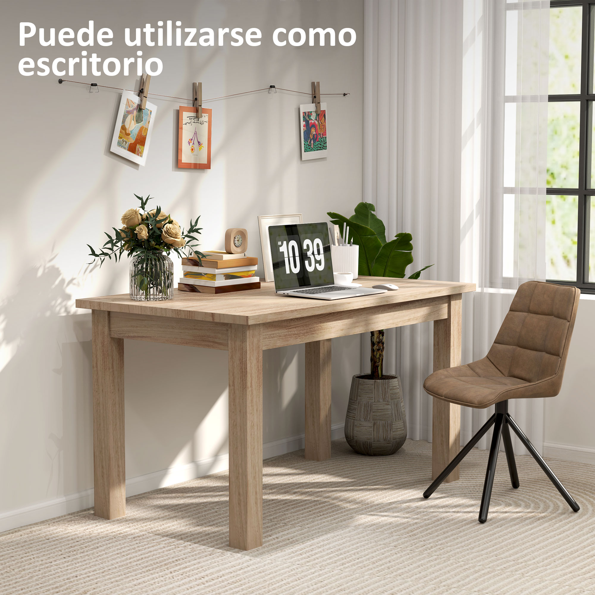 Un escritorio con portátil, libros, flores y silla. Fotos en la pared. Ventana al fondo.