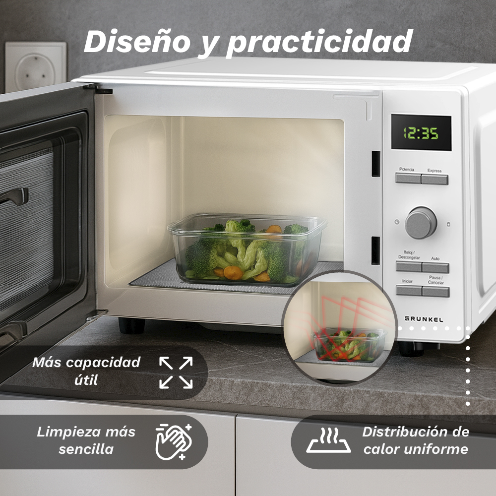 Un horno microondas blanco con la puerta abierta. Dentro, un recipiente con verduras sobre una esterilla. La pantalla muestra 12:35.