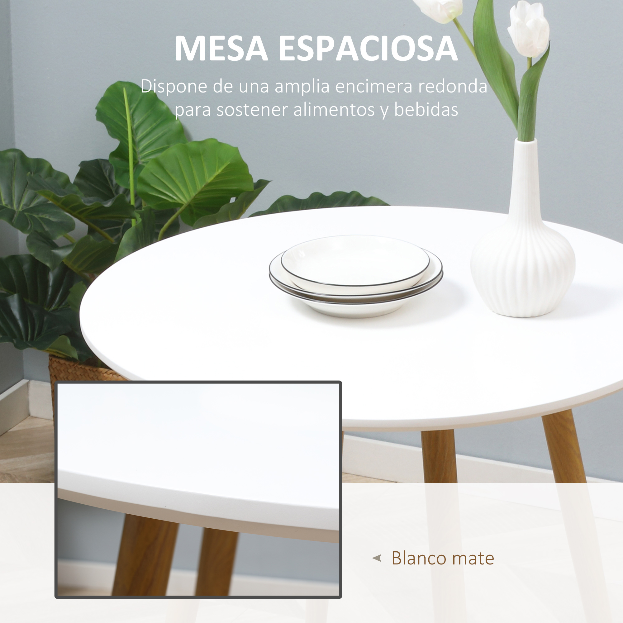Mesa redonda blanca con patas de madera, dos cuencos blancos, un jarrón con flores y una planta en el fondo.