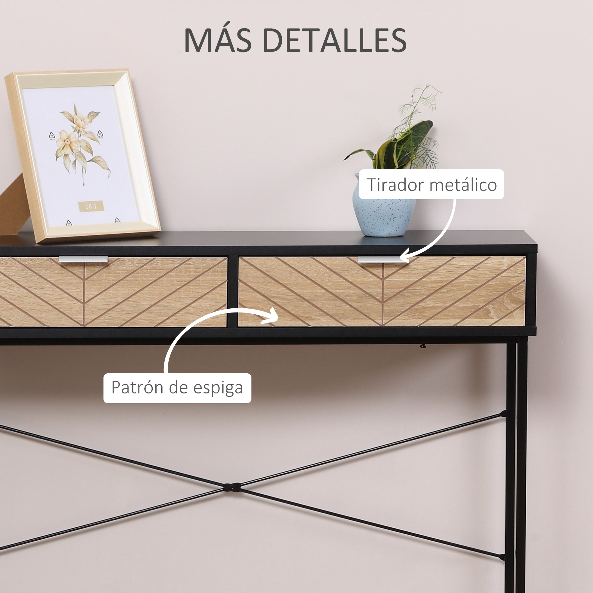 Un escritorio de madera con dos cajones, un cuadro enmarcado y una pequeña planta.
