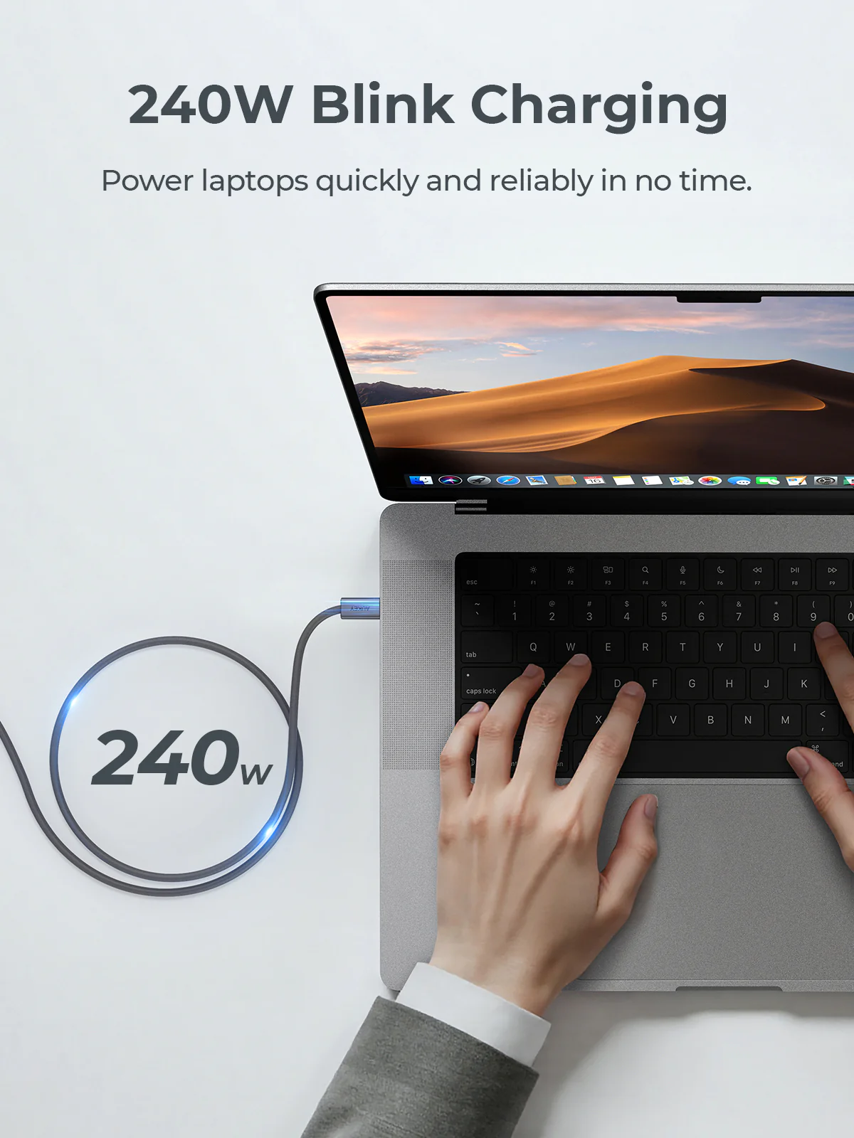 Carga de portátil con cable de 240W. Manos en el teclado. Paisaje desértico en la pantalla. El texto dice 240W Blink Charging.